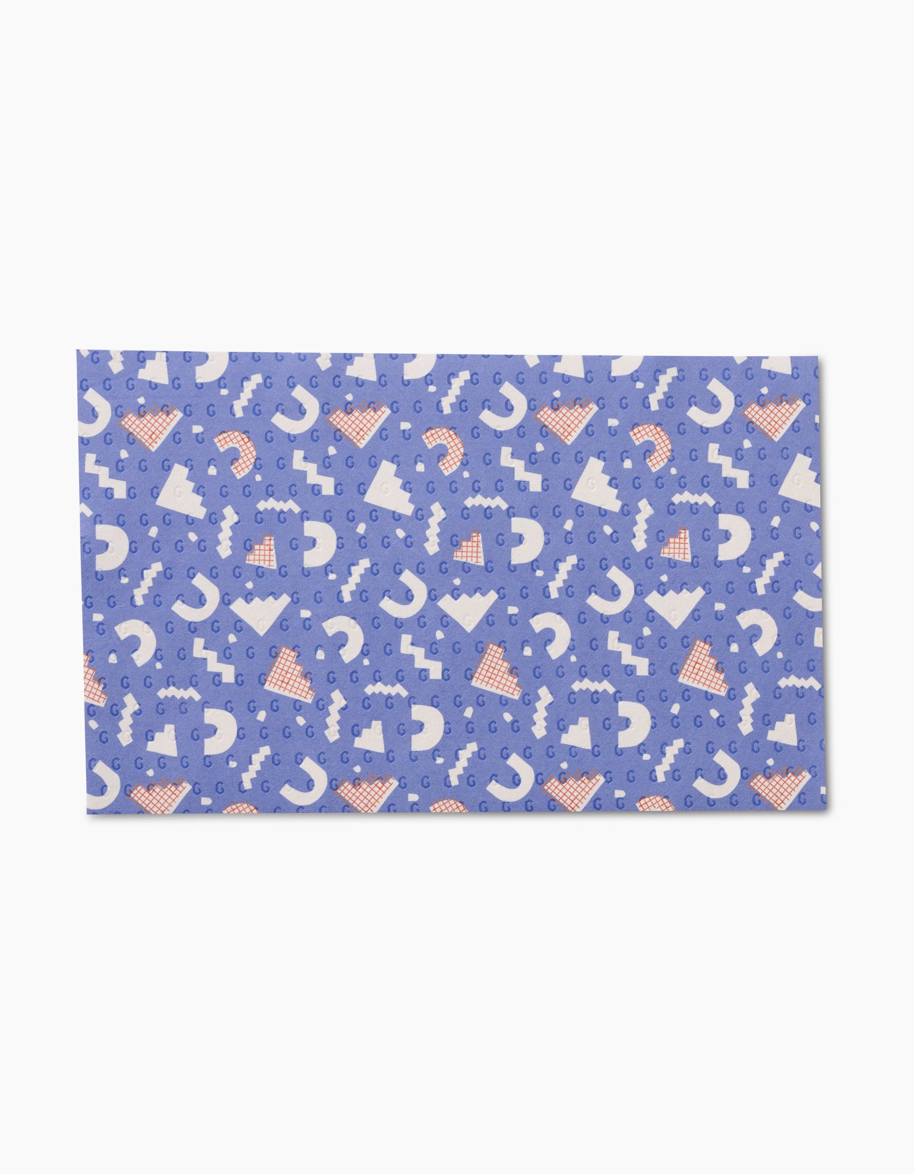 The Claire Iglesias Rainbow Cutouts is a rectangular mat with a blue background and a pattern of white question marks, triangles, and orange polka-dotted hats, made from post-consumer recycled materials for eco-friendly cleaning.