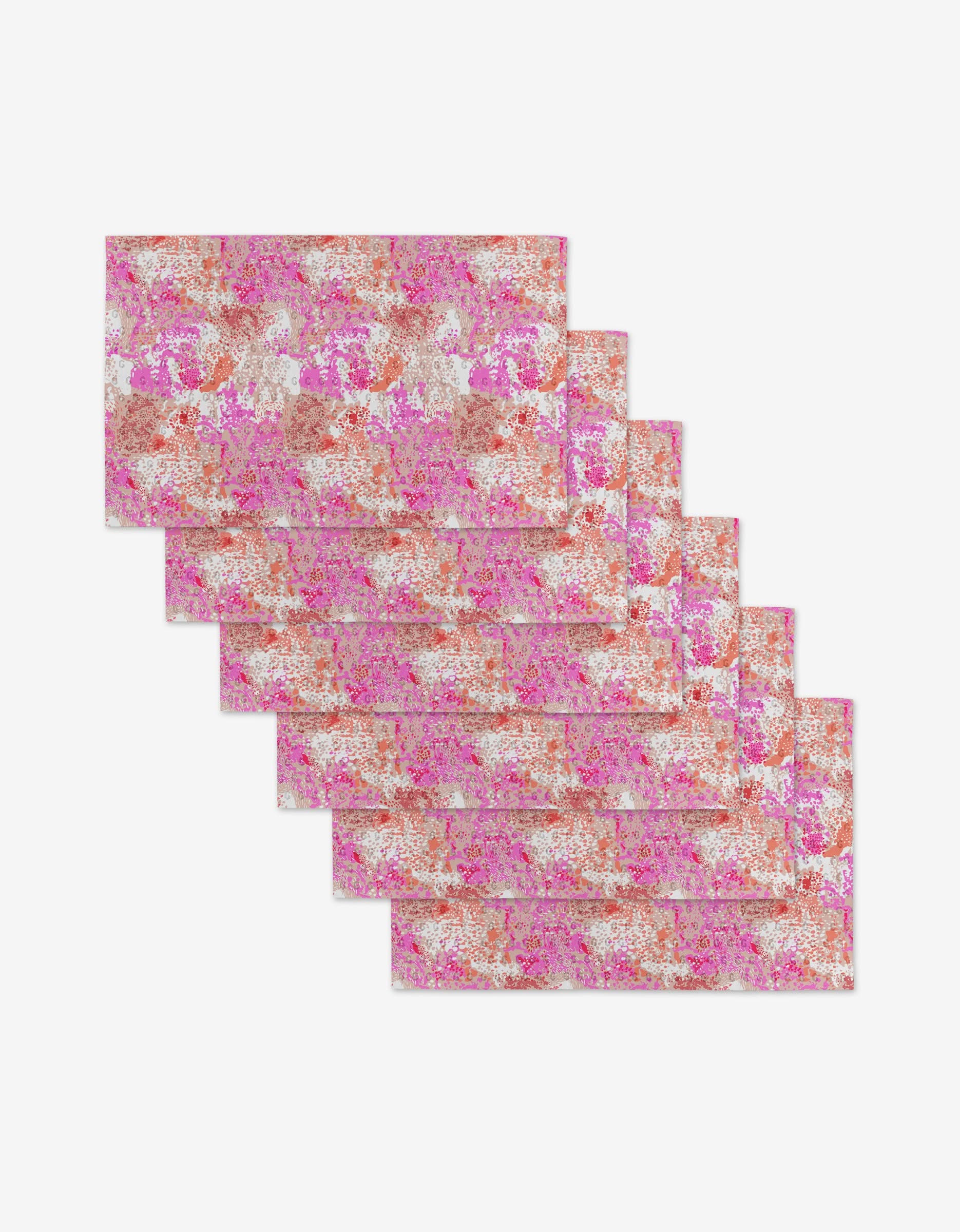 Six rectangular Rawhide sheets by Elisabeth Wing, crafted from eco-friendly recycled materials, feature pink, white, and orange floral or abstract patterns arranged in a fanned display on a white background.