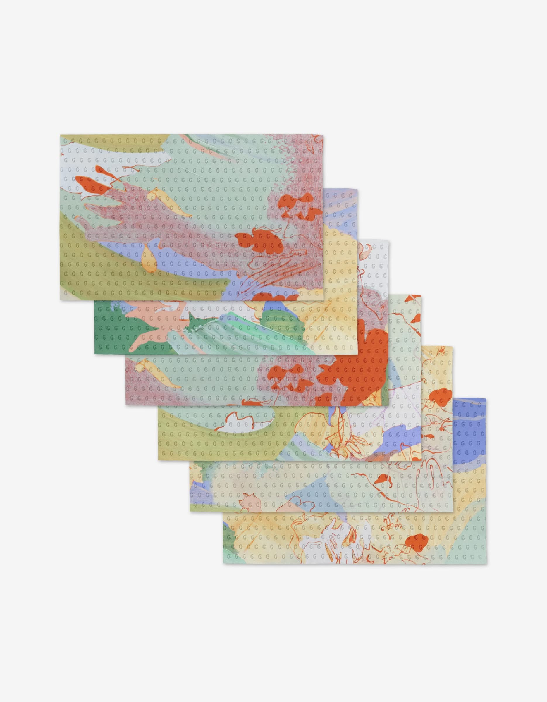 Six Secret Fort rectangular placemats by Kristina Baker, featuring a colorful abstract fish and water design, overlap in a staggered arrangement on white. Made from eco-friendly, reusable materials for sustainable dining.