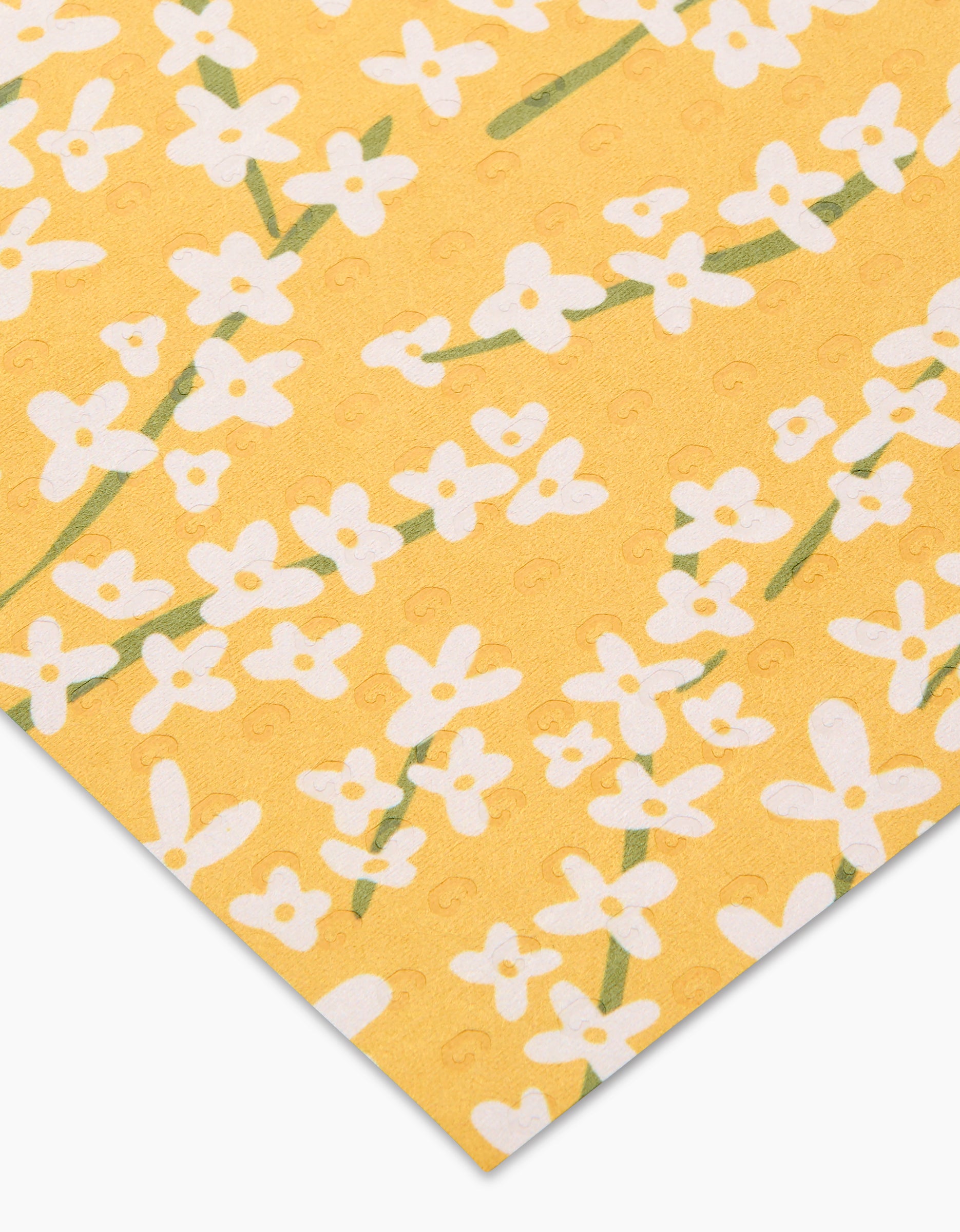 Spring Bounty by Kayla Ann features yellow paper with a white floral pattern of small flowers and green stems, arranged diagonally—ideal for eco-friendly paper towels or recycled cleaning cloths.