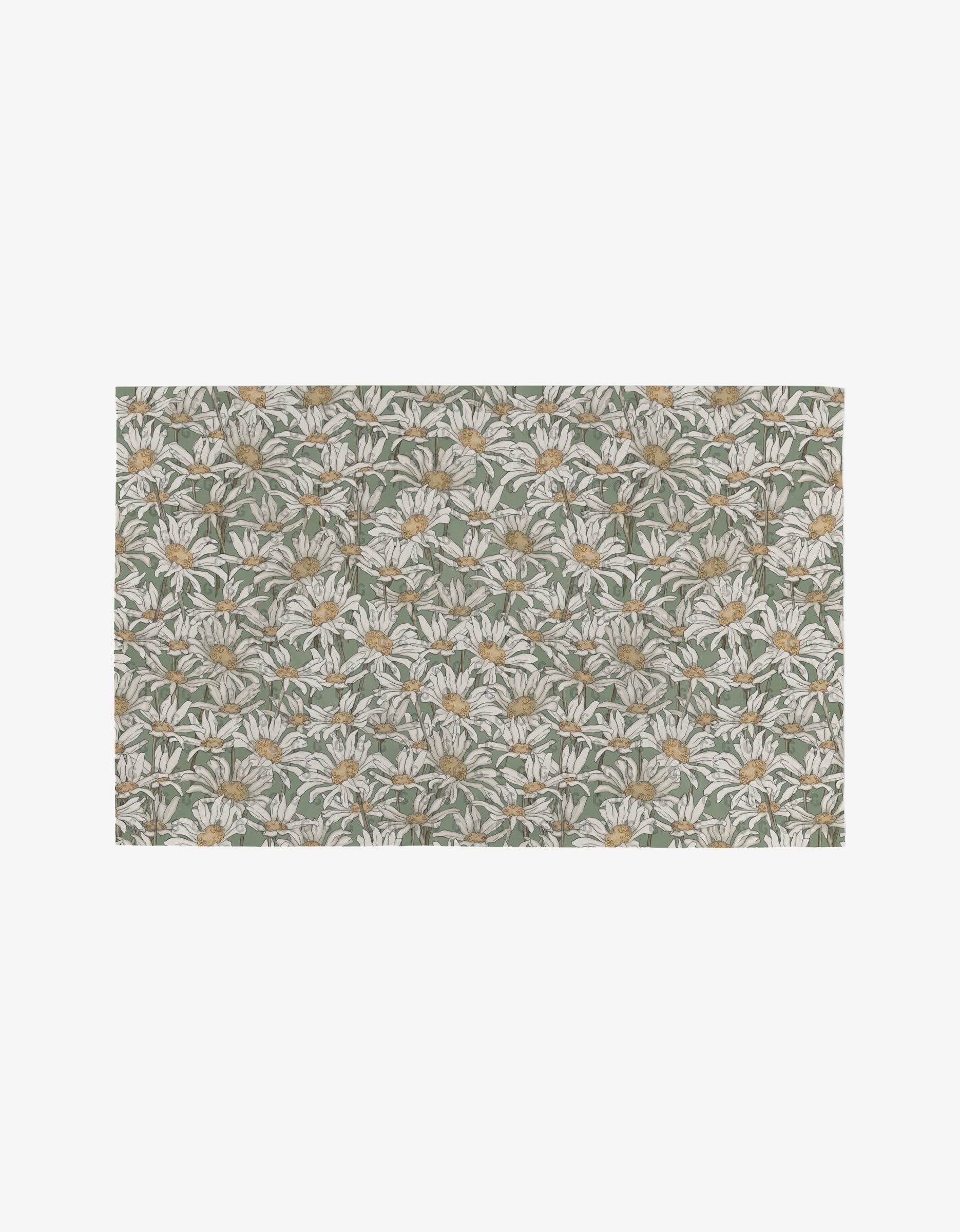 The Springtime mat by Aubrey Fairchild features a dense, evenly spread floral pattern of white daisies with yellow centers and green leaves on a muted green background, made from post-consumer recycled materials.