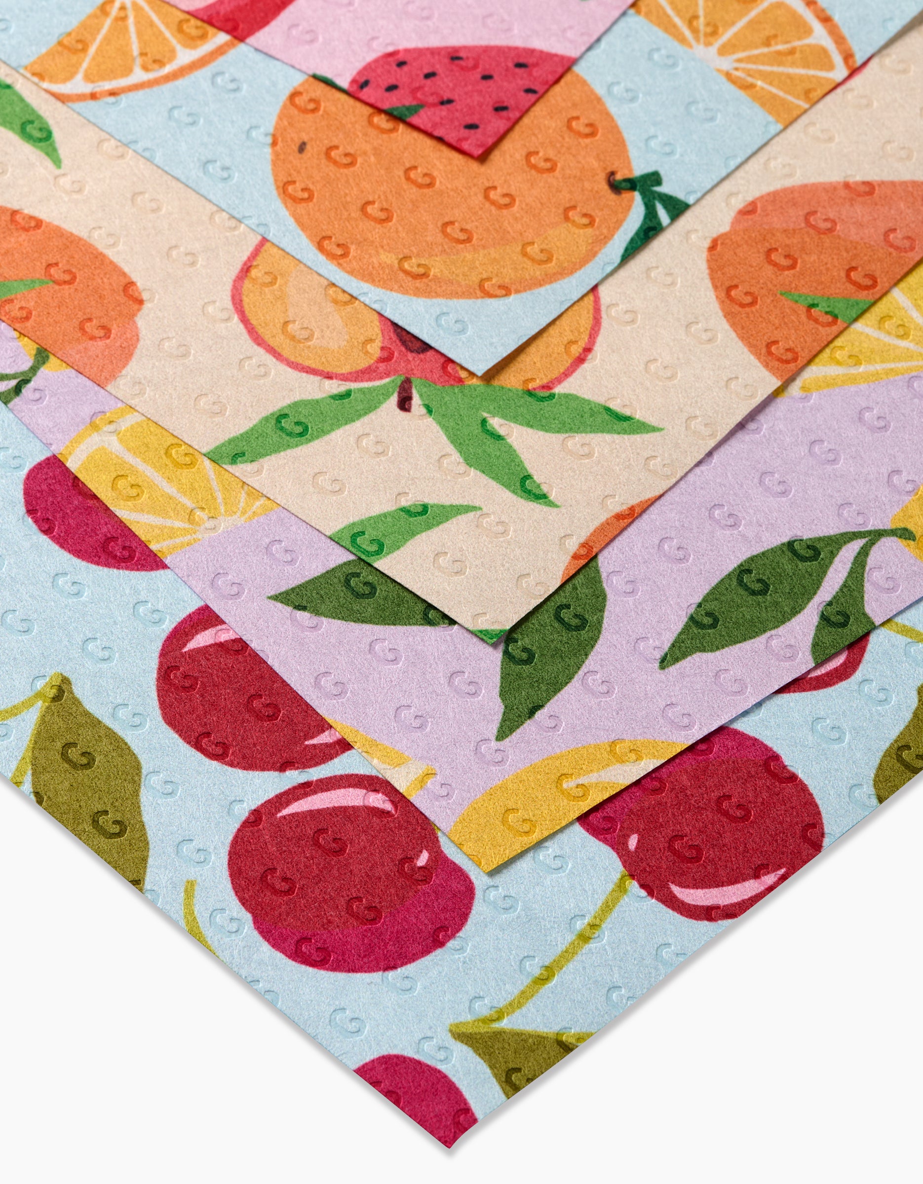 Sweet Summer Mix 1 by GEOMETRY includes four eco-friendly Not Paper Towels with embossed dots, featuring strawberry and orange art on pink, oranges on beige, cherries and lemons on purple, and fruit designs on blue.