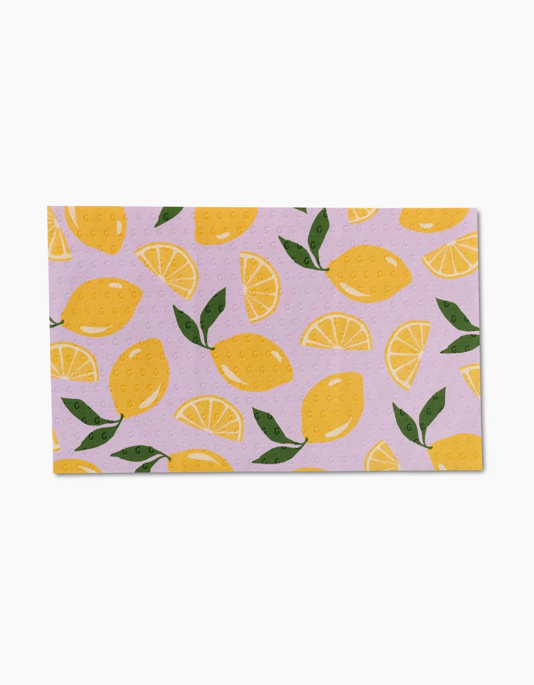 The GEOMETRY Sweet Summer Mix 1 is a rectangular, eco-friendly dishcloth featuring whole lemons, lemon slices, and green leaves on a light purple background—a charming alternative to Not Paper Towels.