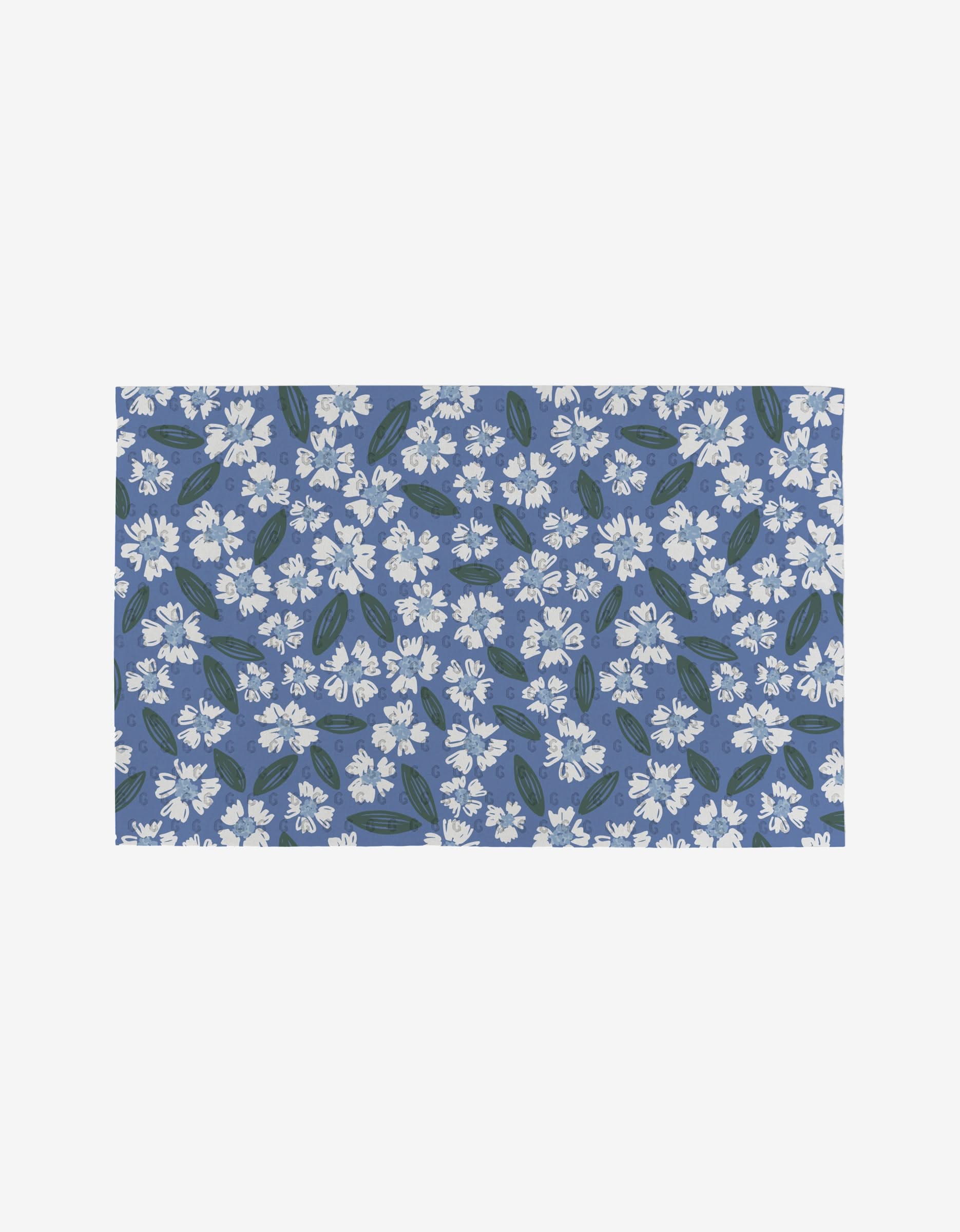 The Sweetie Floral mat by Hufton Studio features a blue background with a repeating white flower and green leaf pattern, and is crafted from eco-friendly recycled materials.