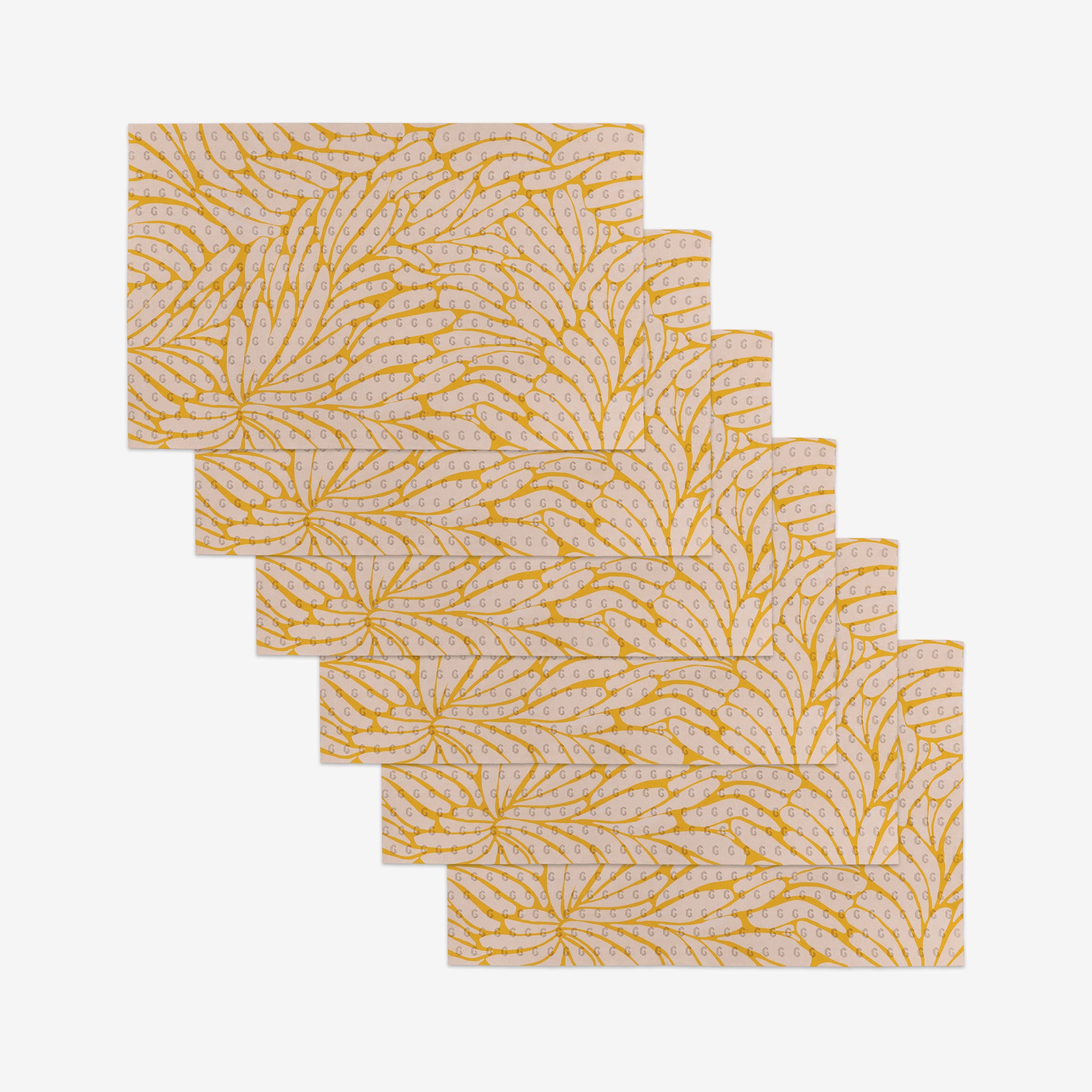 Six reusable rectangular pieces from GEOMETRY’s Tenderhearted collection, featuring a yellow leaf design on a light background, are arranged in a staggered overlap—an eco-friendly Not Paper Towel alternative.