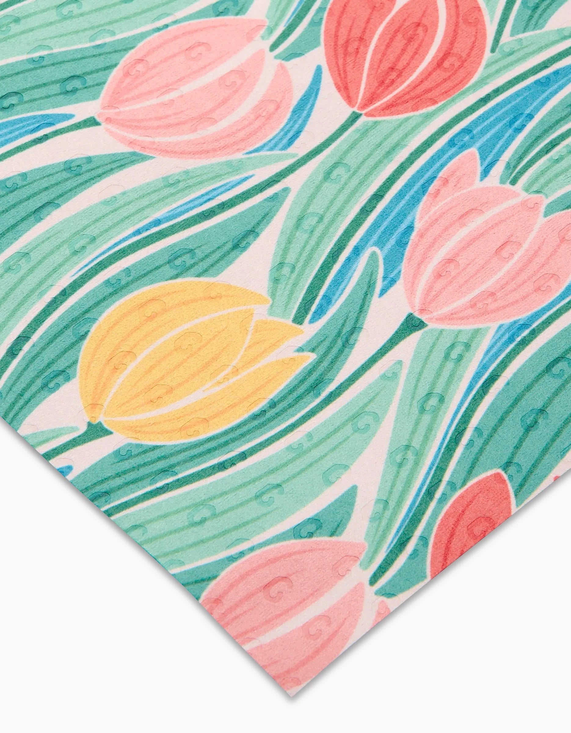 A close-up of Tranquil Tulips by Sarah Daugherty shows eco-friendly, reusable paper with pink, red, and yellow tulip illustrations, green leaves, and swirling details on a white background.