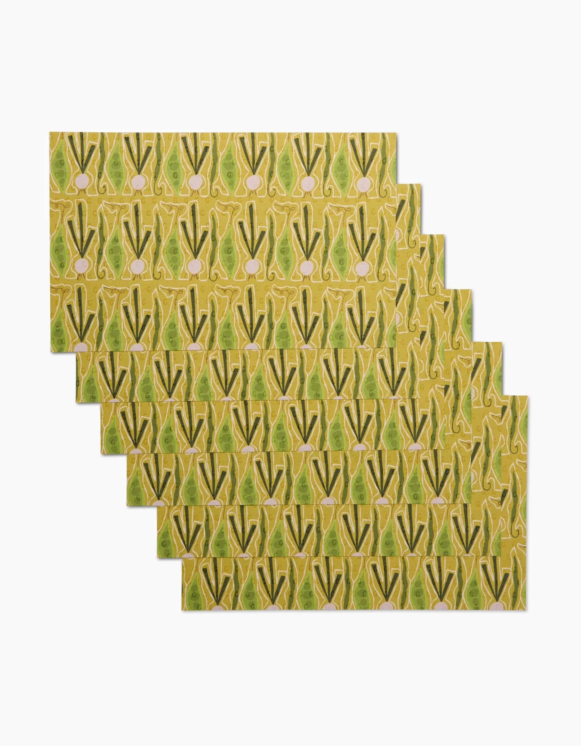 Add an eco-friendly touch to your table with Veg on Parade by Lizzie Clark: a set of six rectangular placemats featuring a repeating green bok choy pattern on yellow, made from post-consumer recycled materials.