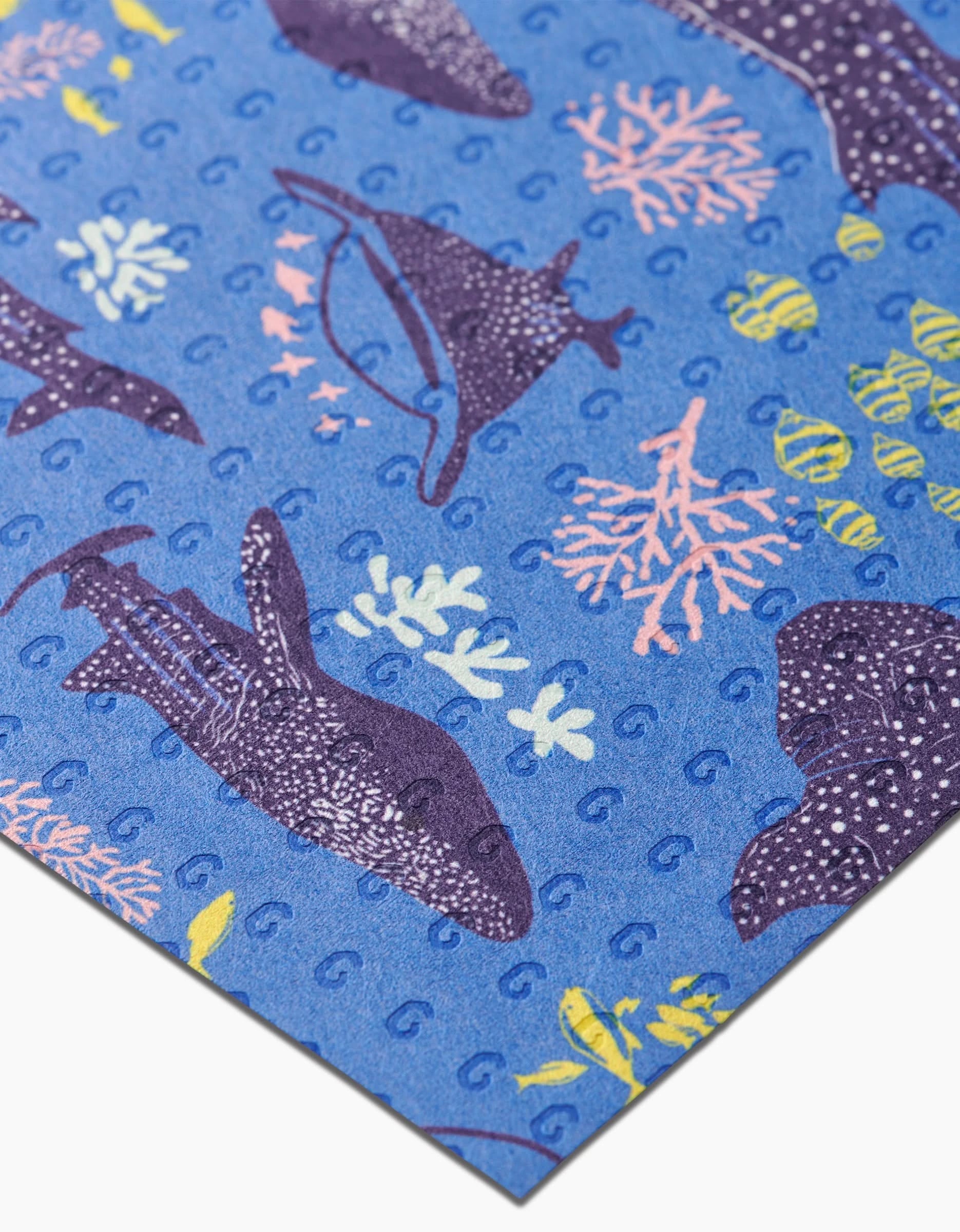 The Whale Shark reusable paper by Elisabeth Wing features a marine-themed pattern with whale sharks, stingrays, yellow coral, and fish in blue, purple, yellow, and pink for an eco-friendly touch.