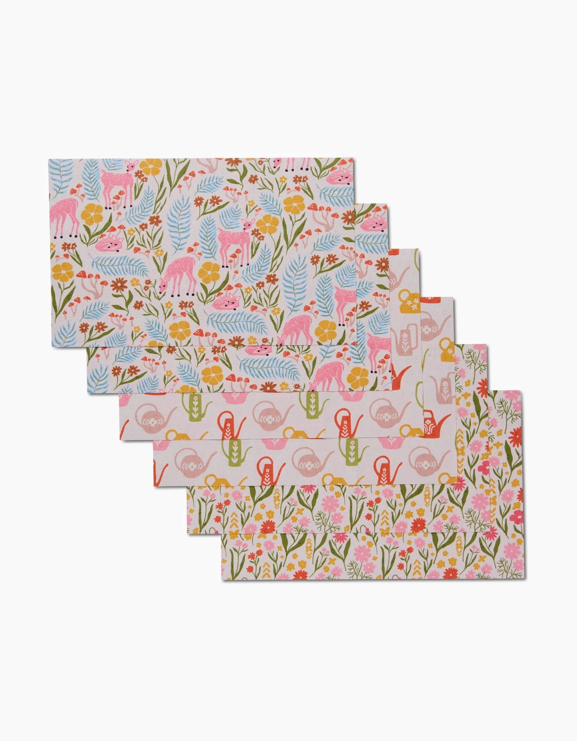 Set of five Whimsy and Retro placemats by Kayla Ann, featuring colorful animal, watering can, and flower patterns on pastel backgrounds—an eco-friendly choice to add charm to any table setting.