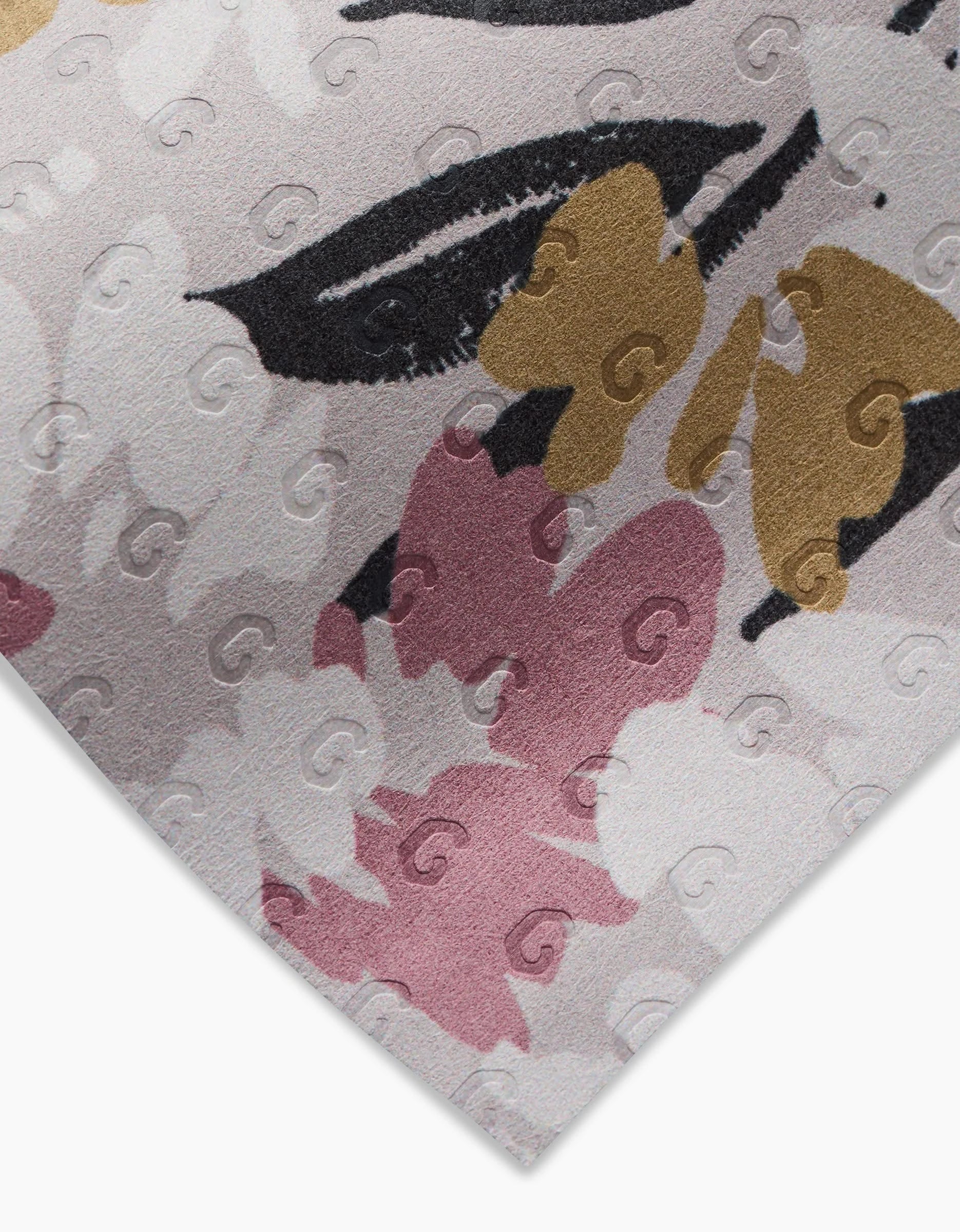 Close-up of Toboggan Avenues Wilderness Floral reusable fabric corner, showcasing a pink, beige, black, and gold floral pattern with subtle embossed swirls—an eco-friendly alternative to Not Paper Towels.