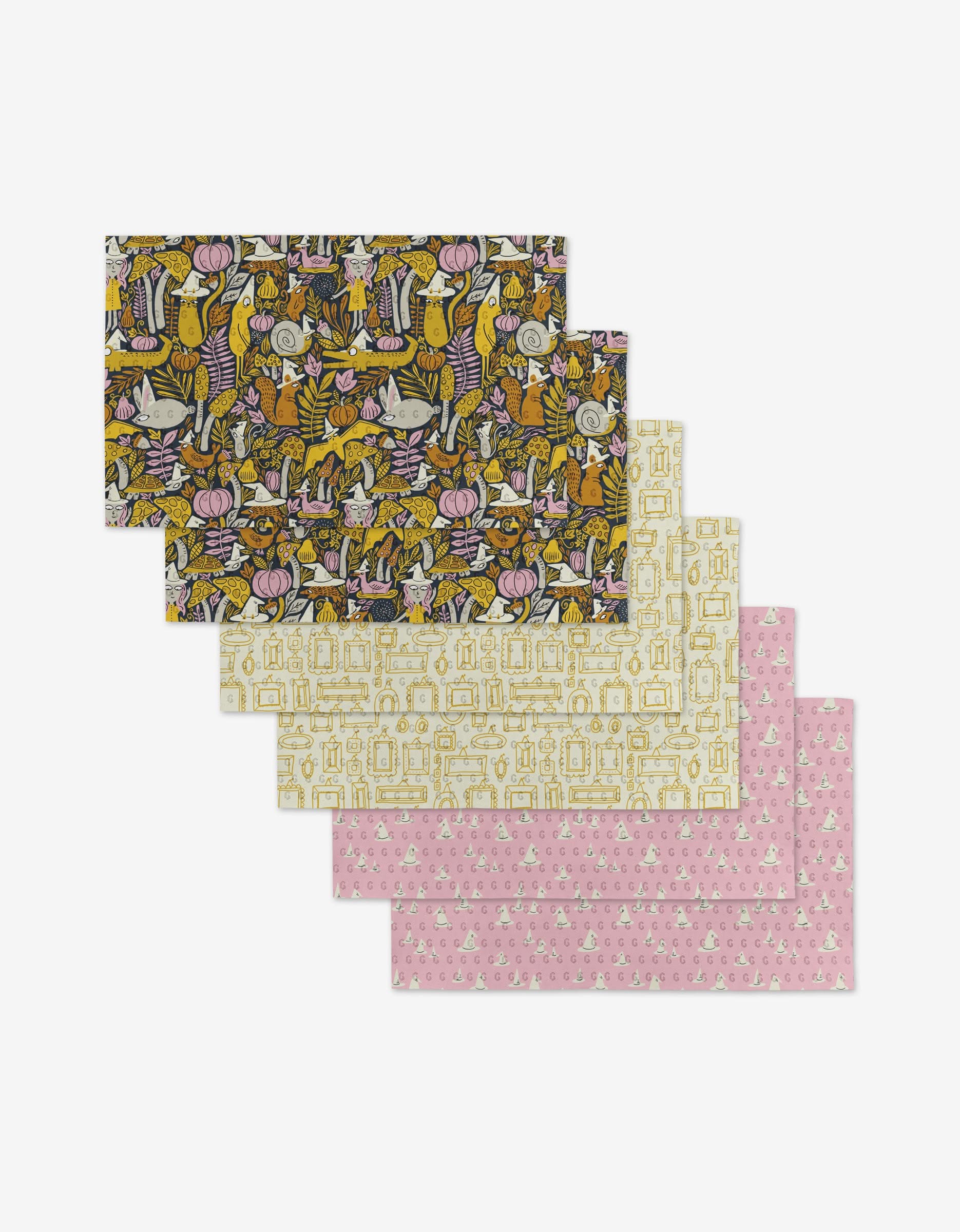 Five reusable rectangular sheets from Amy MacCready’s Witchy Season collection, fanned out. The top sheet shows a vibrant botanical and animal design; the others have subtle white, beige, and pink motifs—eco-friendly paper towel alternatives.