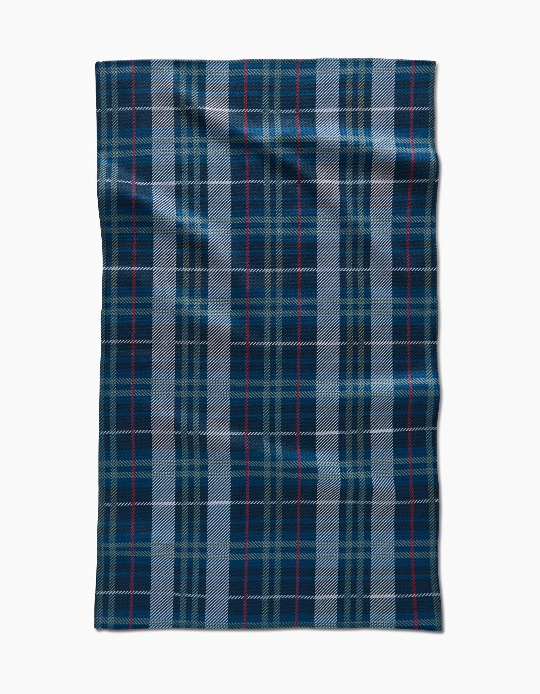 The Becki Owens Scotty is a rectangular wool blanket, crafted from recycled materials, featuring a blue, black, and white tartan plaid with thin red lines, displayed flat on a white background.