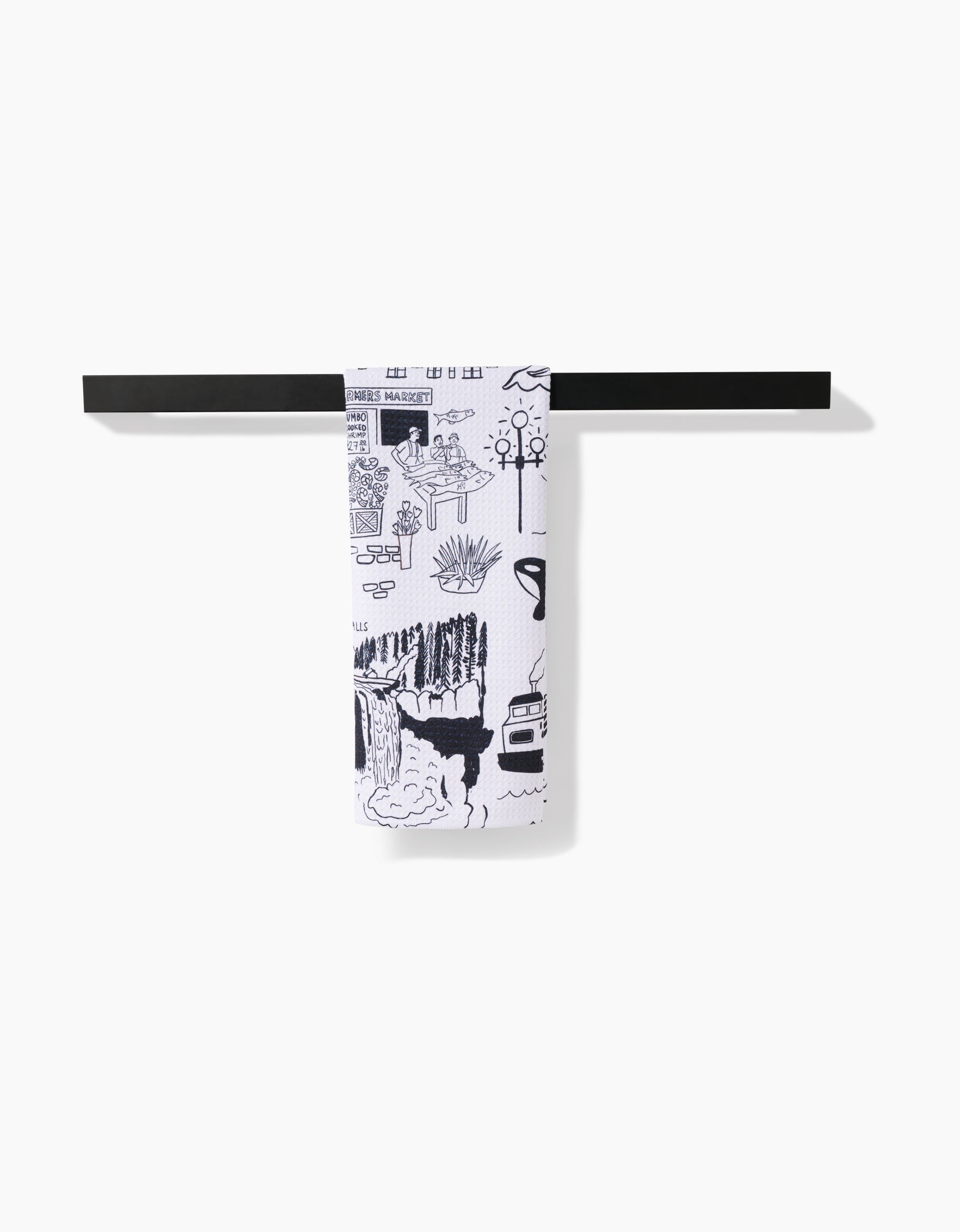 The Elisabeth Wing Seattle white tea towel, featuring black illustrated designs and made from recycled materials, hangs neatly folded over a simple horizontal black towel bar against a white background.