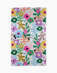 The Abstract Botanicals towel by Marina Solodka is rectangular and ultra-absorbent, featuring pink, yellow, green, and purple flowers with whimsical leaves and dots on a white background.