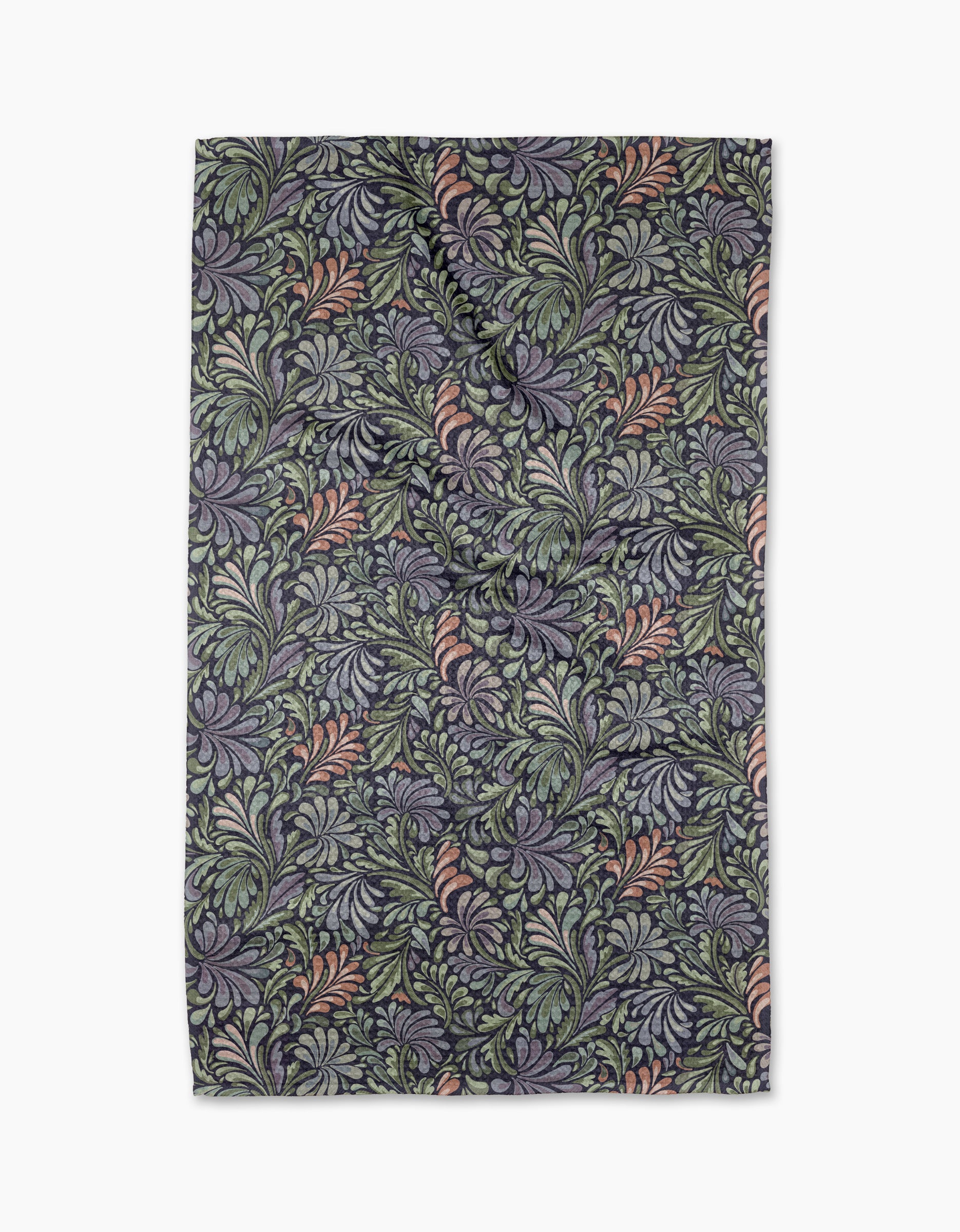 The "Acanthus" tea towel by Kris Ruff features an intricate floral pattern in green, lavender, and muted pink on a dark background with swirling leaves and vines. Made from recycled materials, it is shown slightly wrinkled against a white backdrop.