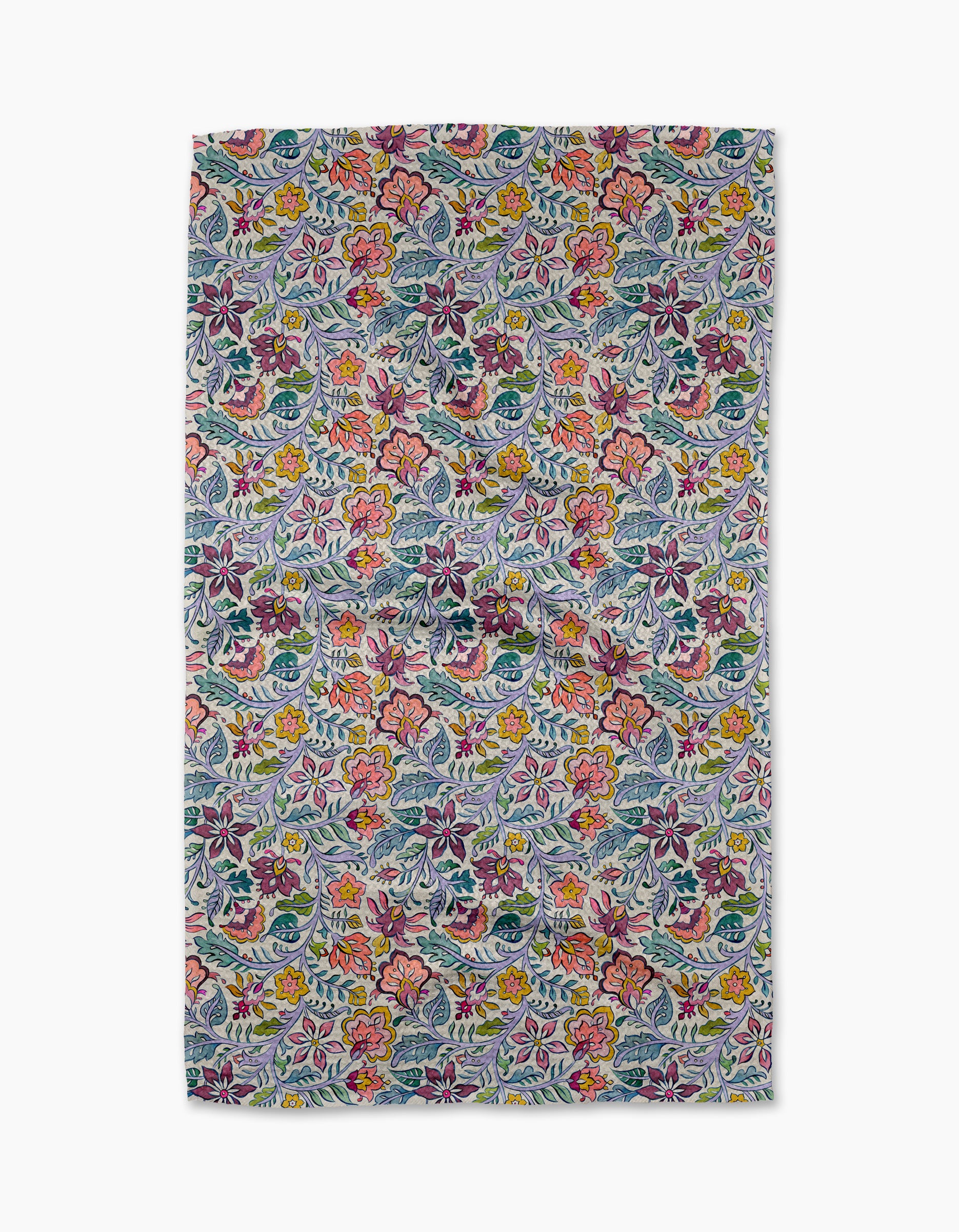 The Amethyst towel by Maayan Alper-Swan is rectangular and ultra-absorbent, featuring a vibrant, dense floral pattern in red, yellow, pink, blue, and green on a light background for an intricate, colorful look.