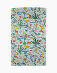 The Mindfulnice “Beneath the Waves” tea towel has a vibrant underwater scene with sea life on a light background—perfect for adding color to your kitchen décor.