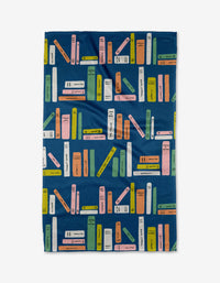 The Bookish Stripes blanket by Amy MacCready features rows of colorful books on navy blue, with green, yellow, pink, and orange covers. Made from recycled materials for an eco-friendly touch.