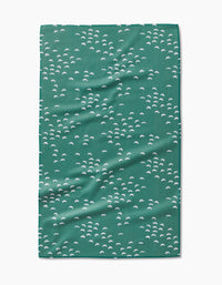 The Breezeway tea towel by Jessica Swift features a repeating pattern of small white semi-circular shapes on green, made with ultra-absorbent Geoweave fabric. The towel is shown flat with slight wrinkles visible.