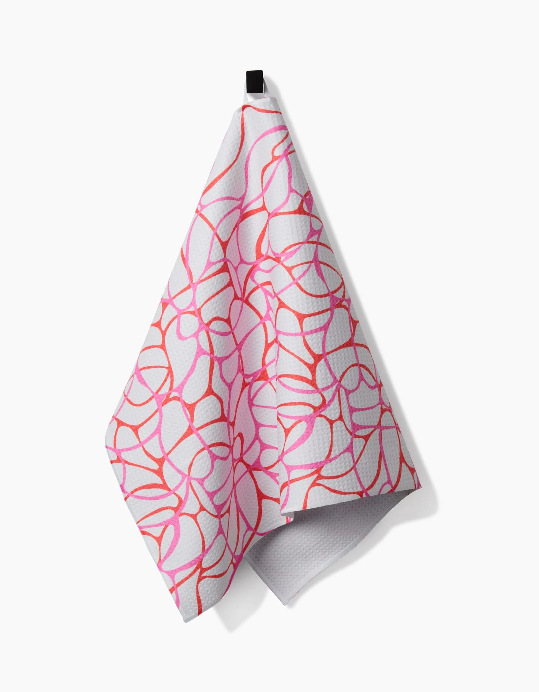 The Rachel Parker Bubble Abstract Tea Towel, featuring a pink and red abstract floral pattern, hangs from a black loop against a white background. It is crafted from recycled materials.