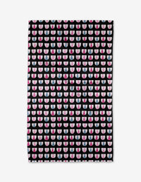 The Bug Boogie tea towel by Anette Heiberg is made from ultra-absorbent Geoweave fabric and displays neat rows of pink, white, and red half circles on a black background.