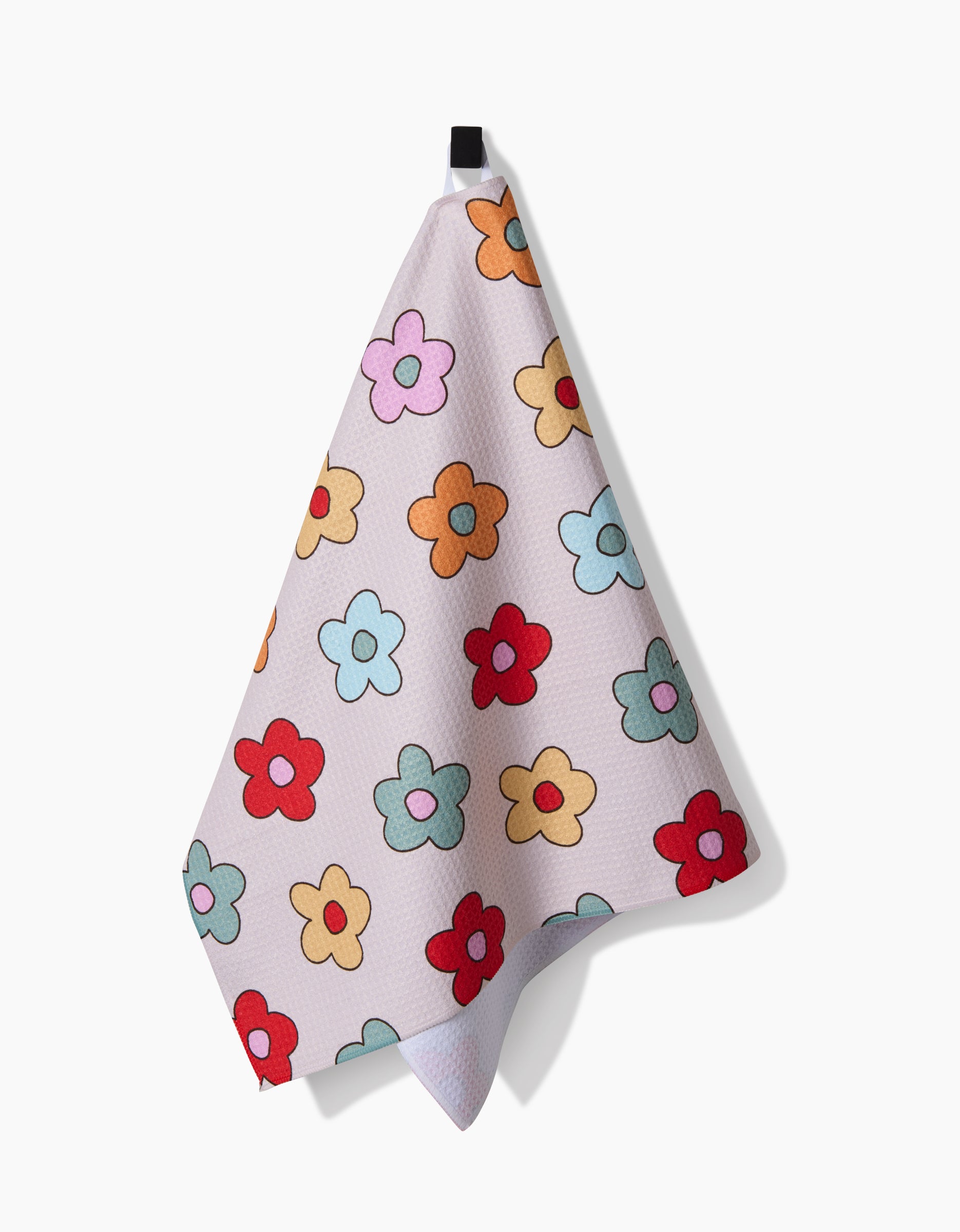 The Purely Kaylie Buttercream Blossoms Tea Towel features colorful cartoon-style flowers on ultra-absorbent Geoweave™ fabric and hangs from a black loop, set against a plain white background.