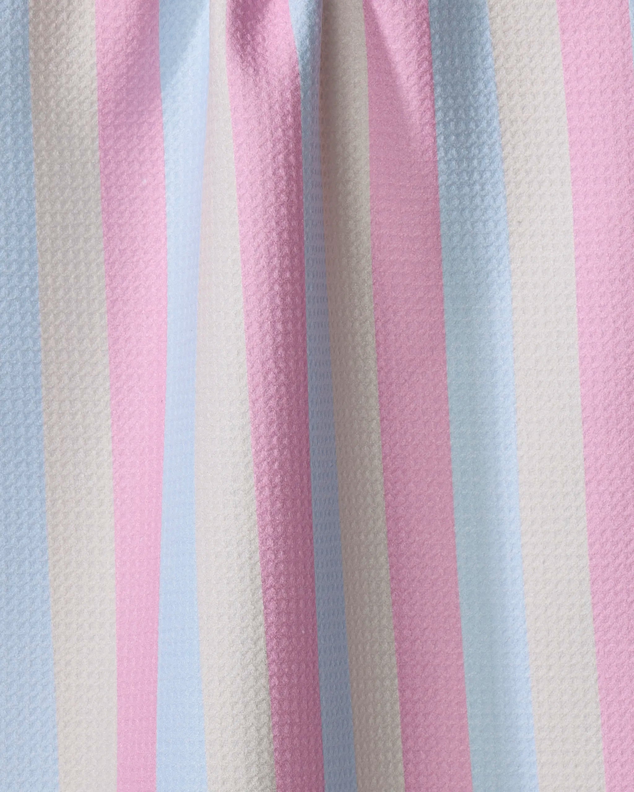 Candy Pastels by Amy Droubay features vertical pastel stripes in blue, pink, cream, and white on textured, lightly gathered fabric—evoking a cozy vibe and perfect as a recycled tea towel for your home.