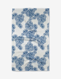 The Celia tea towel from Second Nature Studio is a rectangular, ultra-absorbent white towel made from recycled materials, featuring a repeating blue floral pattern with diagonally arranged clusters.