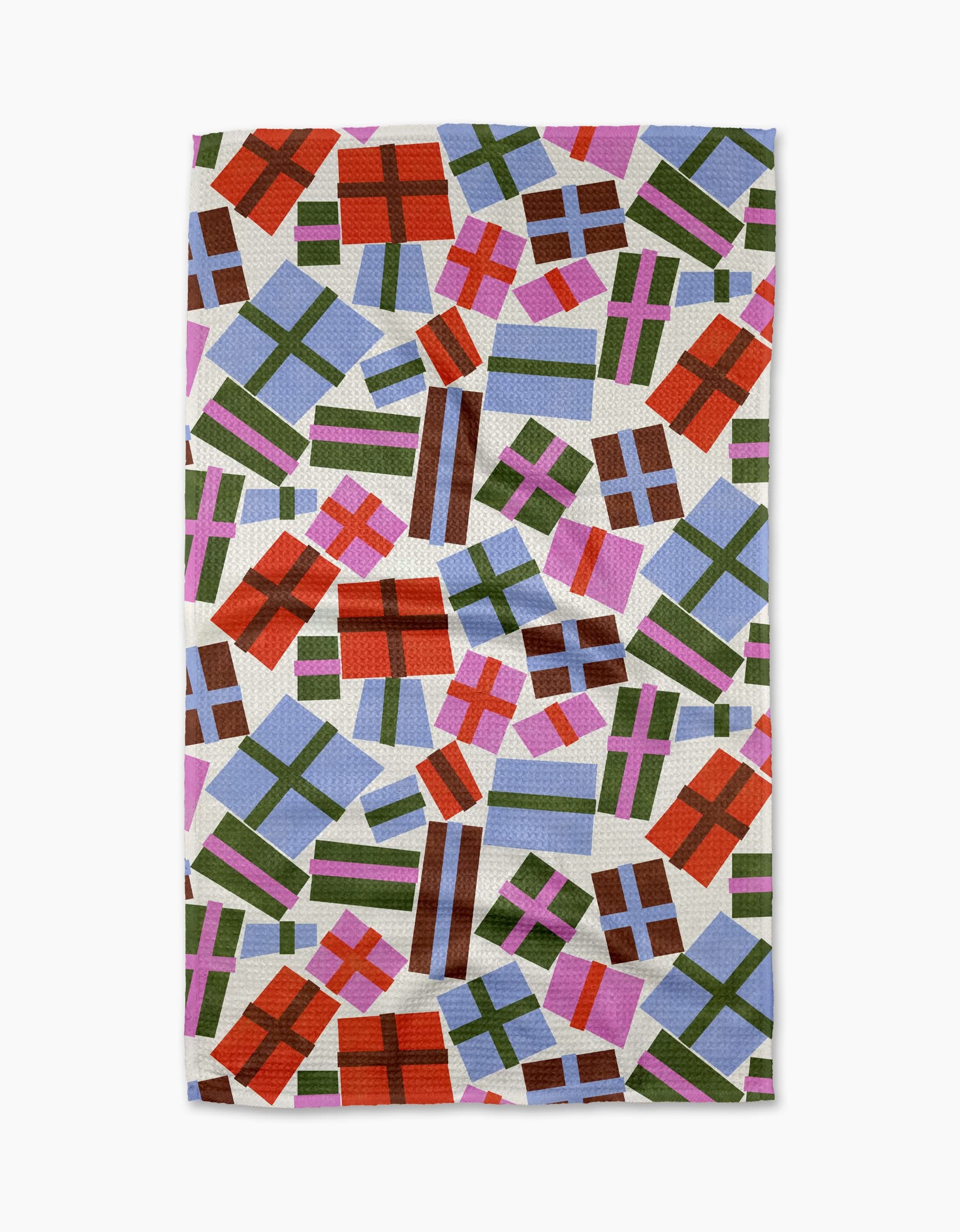 The Cheerful Presents tea towel by Claire Iglesias showcases colorful, gift box-inspired rectangles with green, red, brown, and purple ribbons on a white background.