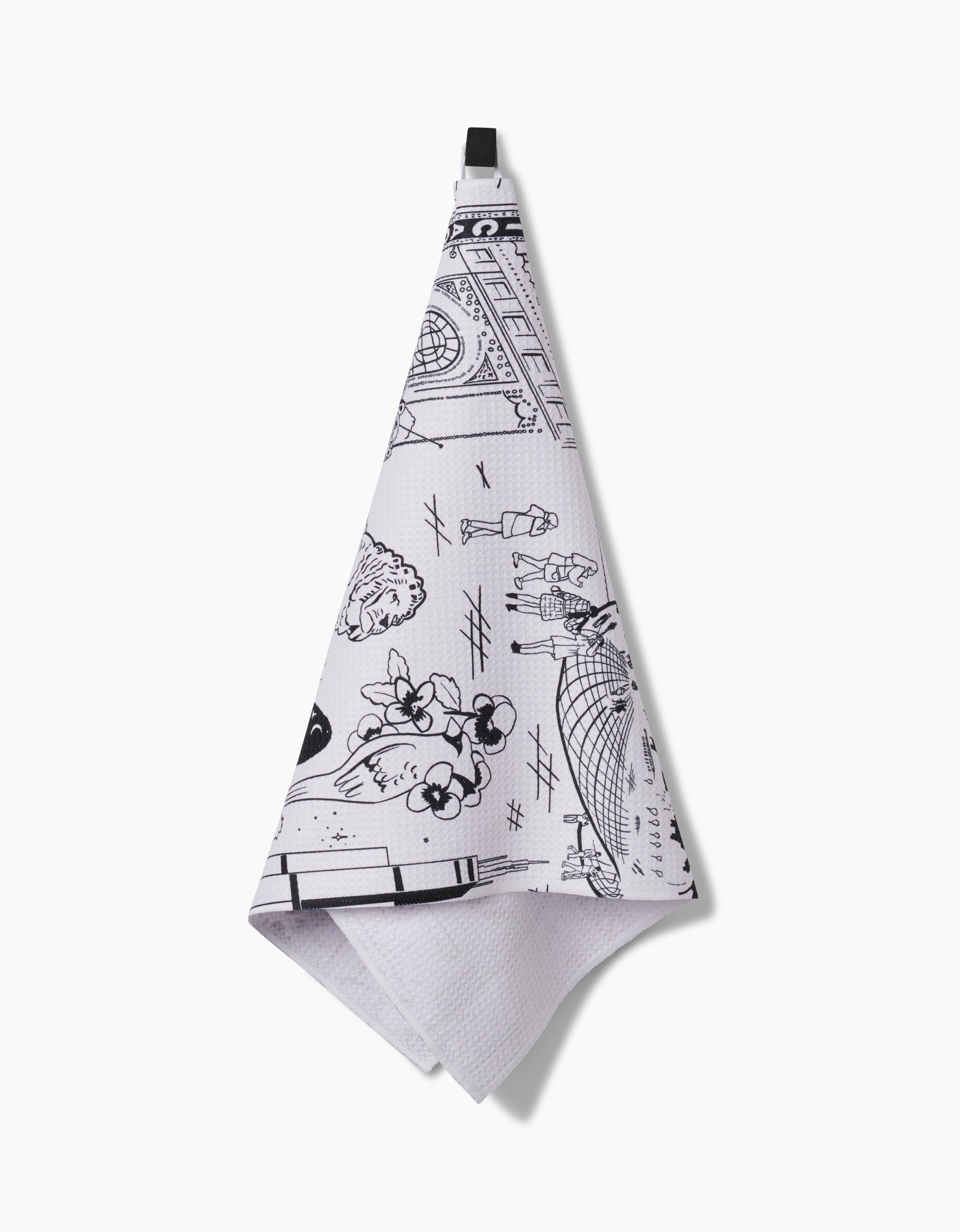 The “Chicago” tea towel by Elisabeth Wing, made from Geoweave fabric, showcases black line art of city scenes and architectural details. It hangs from a black loop against a white background.