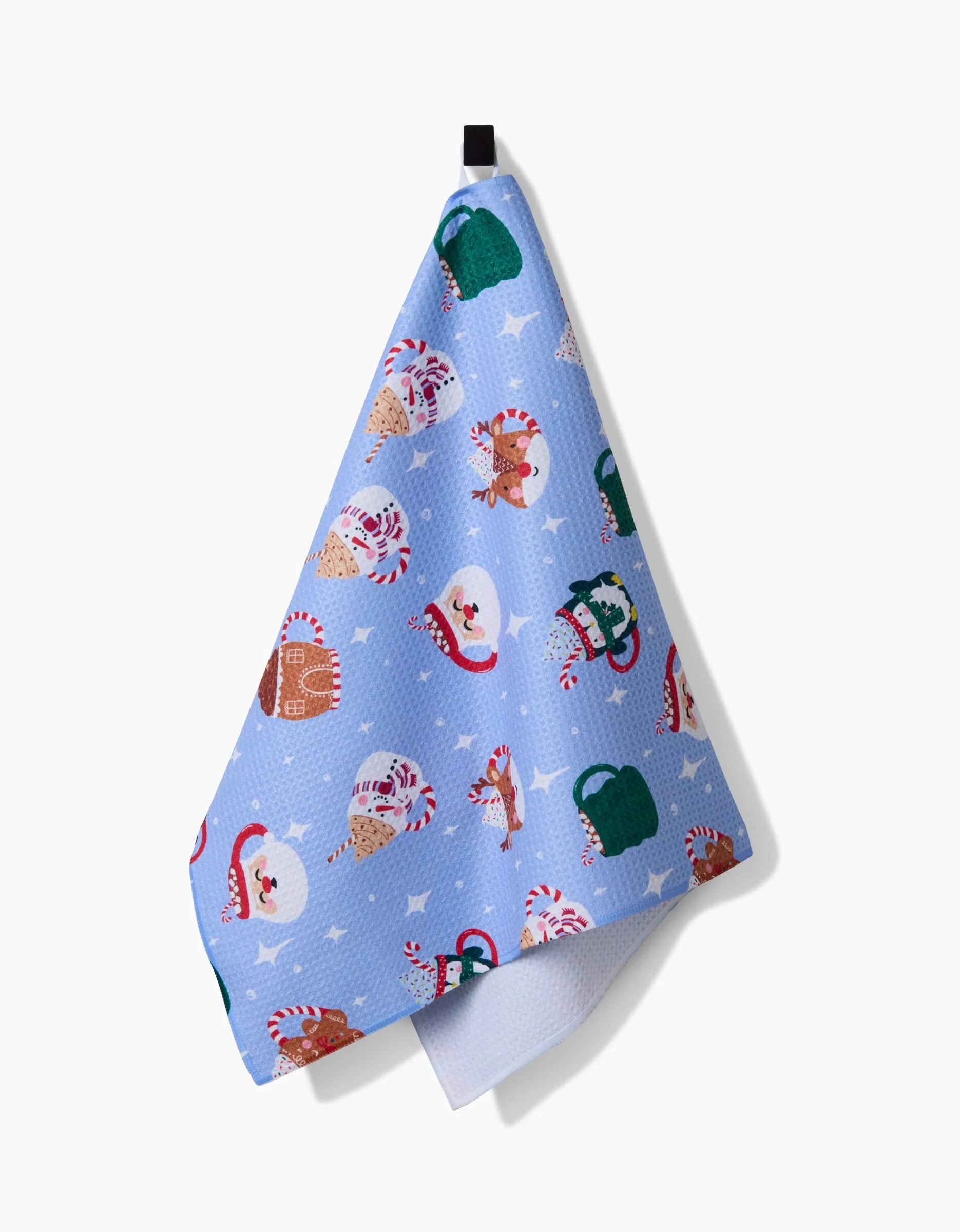 A festive Christmas mug by Vaishali Design Studio, featuring cheerful Santa faces, candy canes, mittens, stockings, and stars, is showcased against a white background.