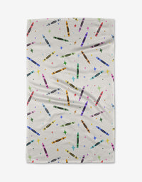 The Vaishali Design Studio Colored Crayons tea towel features a colorful crayon and multicolored star pattern on white, made from quick-drying recycled materials with a slightly wrinkled texture for charm.