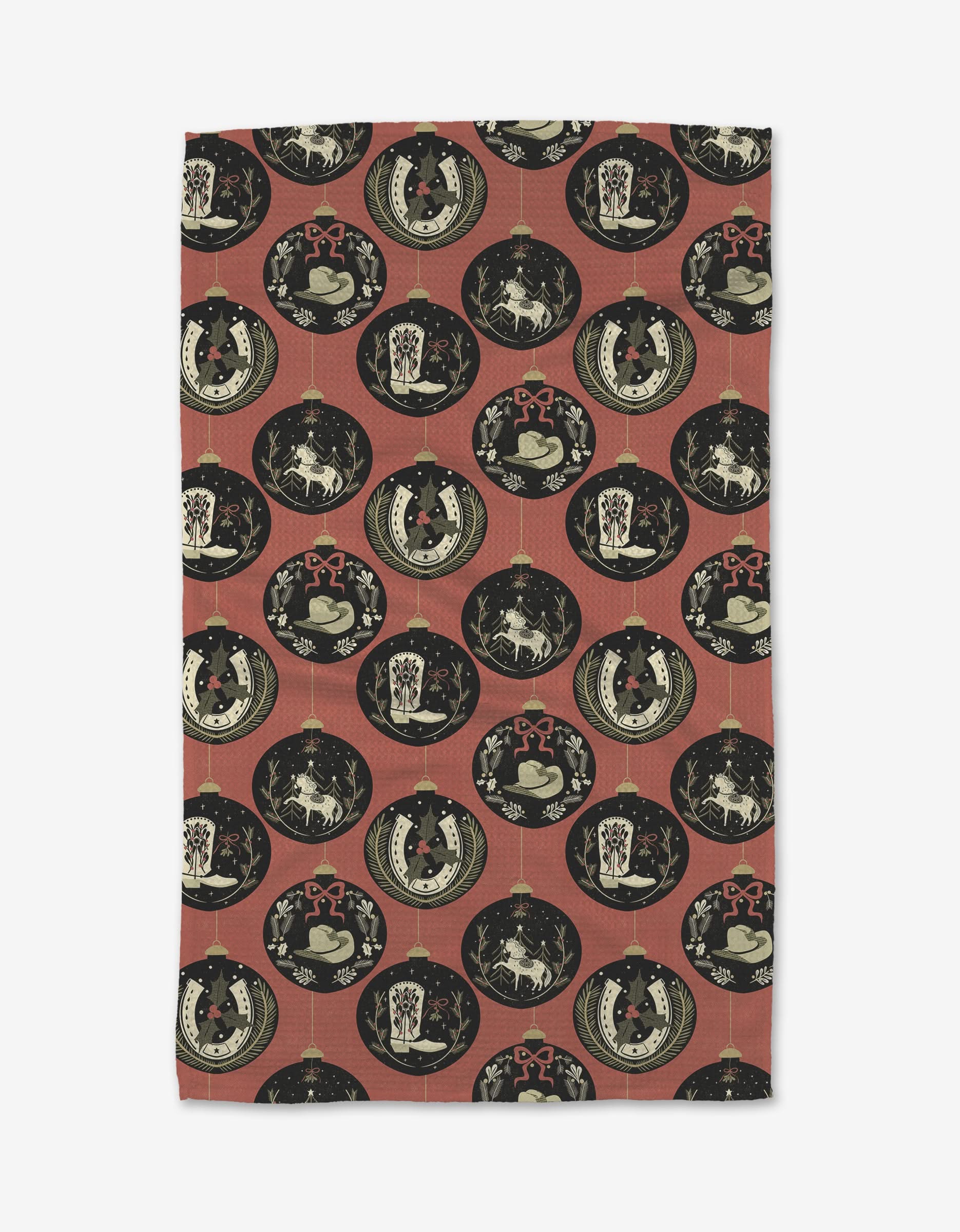 The Julianne Haness Country Ornaments tea towel features a repeating pattern of vintage cats, dogs, and florals in black, cream, and red on a muted red background.