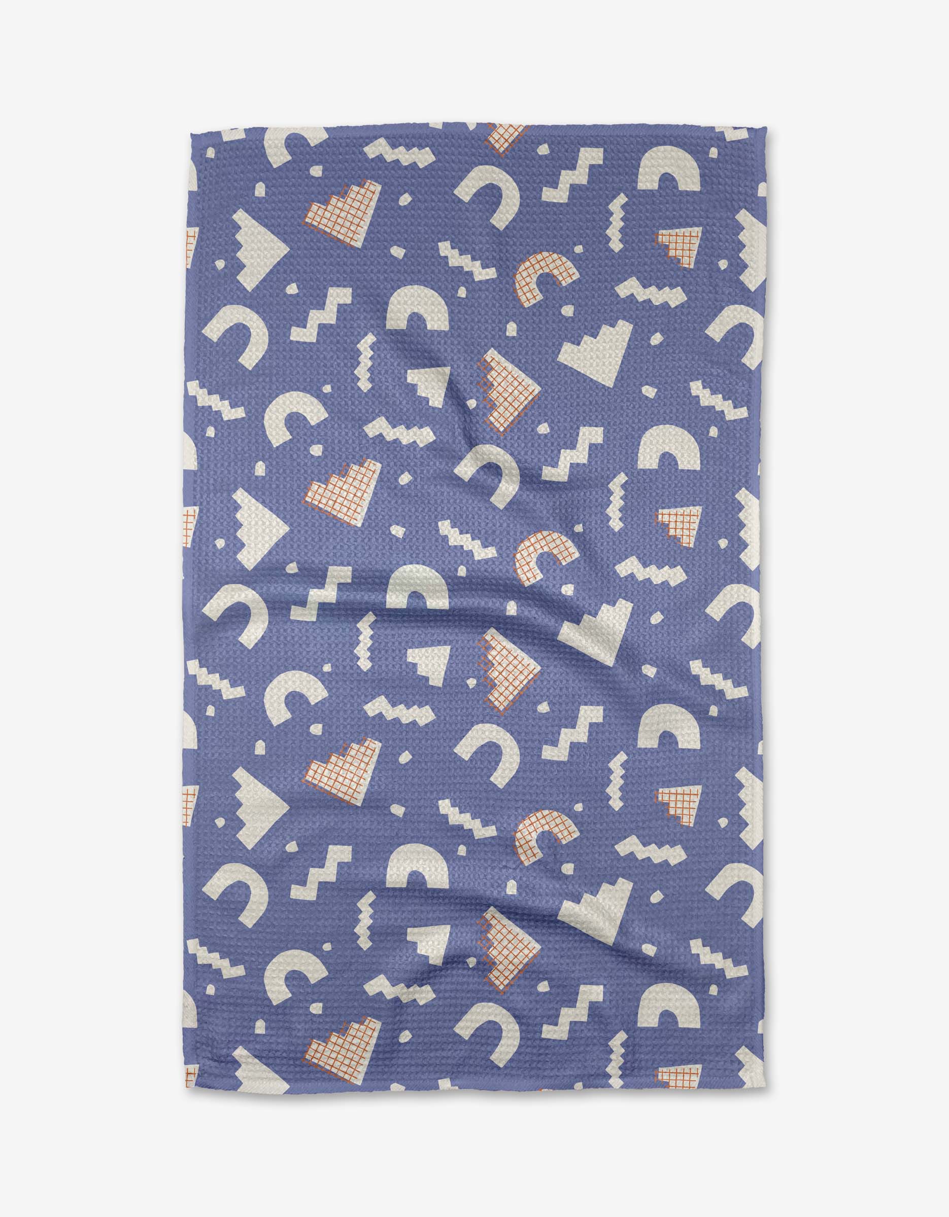 The Cutout Shapes tea towel by Claire Iglesias is rectangular and blue, with playful white semicircles, zigzags, and peach triangles. Made from quick-drying recycled fabric, slight wrinkles may be visible.