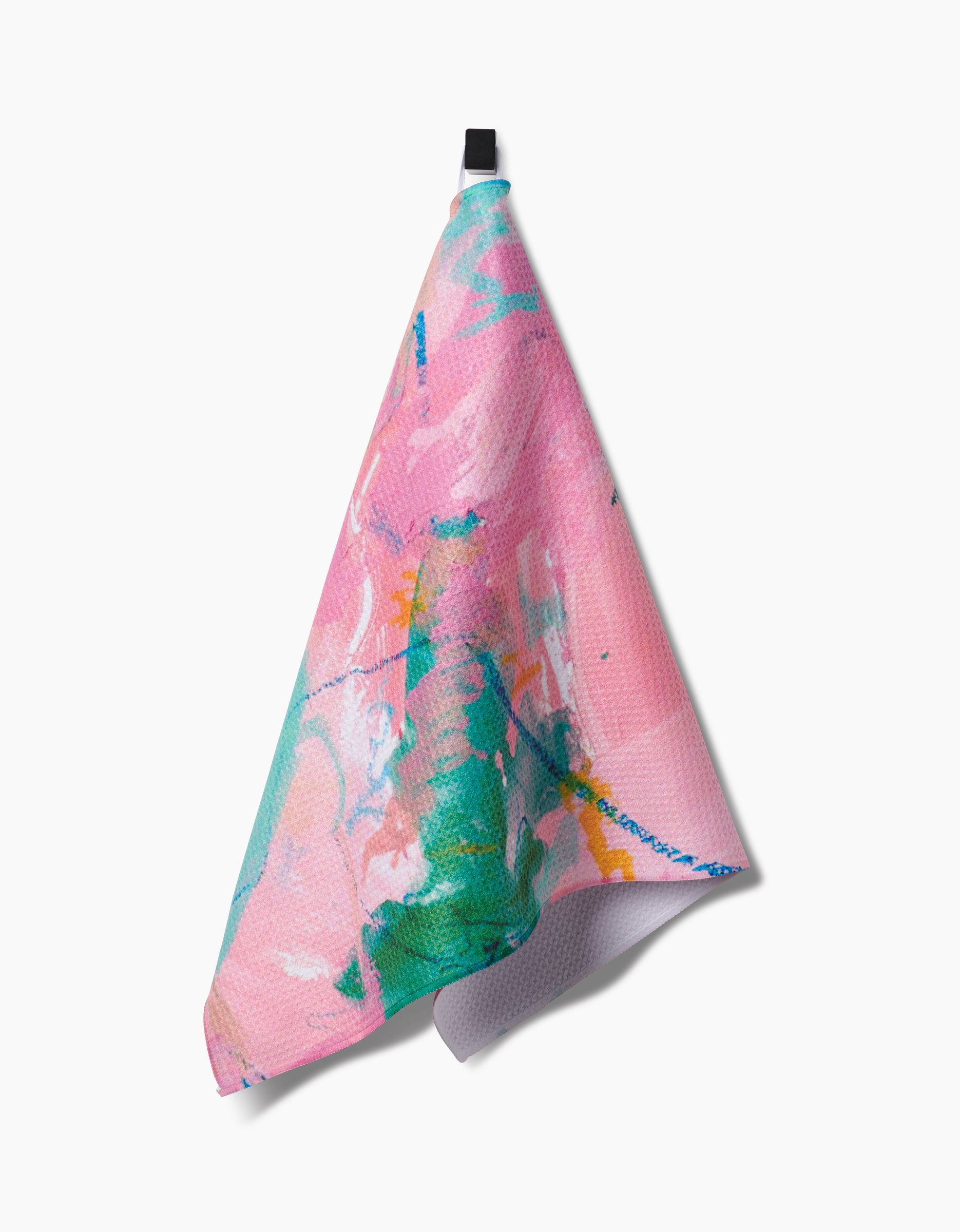 The Daughter tea towel by Sarah Holden features a pink, turquoise, and orange abstract pattern on recycled material and hangs from a black loop against a white background.
