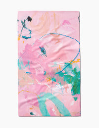 The Daughter tea towel by Sarah Holden features an abstract, colorful design with pink, green, blue, orange, and yellow brushstrokes and scribbles on a light pink background. Made from recycled materials.