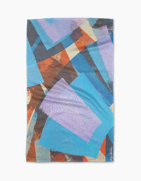 Echoes of Color by Skye Walker is a rectangular quick-drying towel with overlapping geometric shapes in blue, purple, orange, and beige for a dynamic look. The artist’s signature is featured in the bottom right corner.