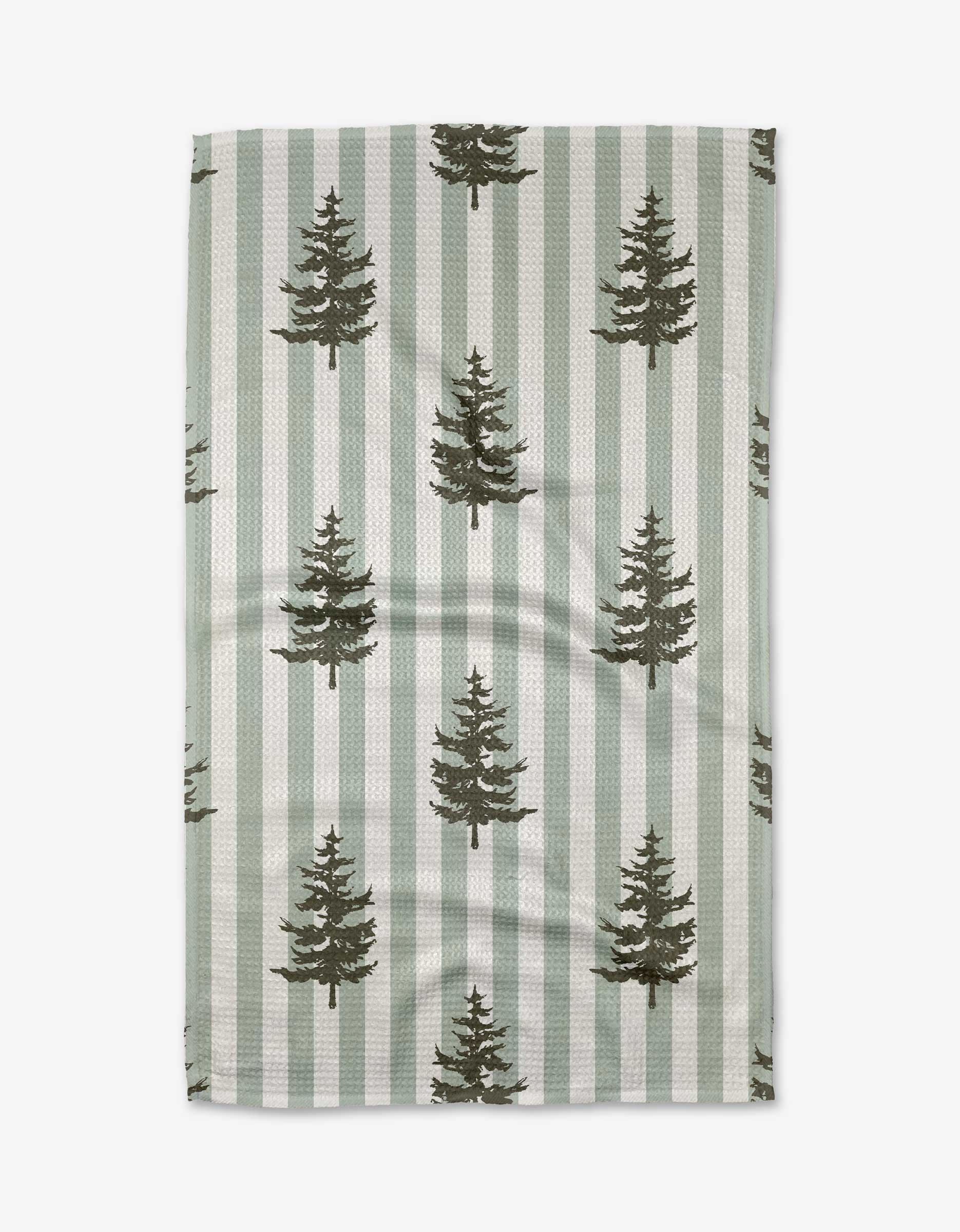 The Fir Real tea towel by Kelsi Fullmer is ultra-absorbent, made from recycled materials, and features green and white vertical stripes with evenly spaced dark green pine trees.