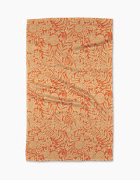 The Florence tea towel by Katie OShea is rectangular and features an intricate orange and beige floral pattern with leaves and flowers covering the entire surface.