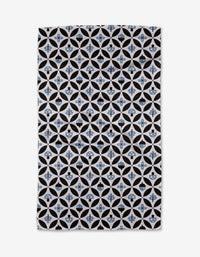 The Anette Heiberg Forest Findings Tea Towel showcases a repeating geometric pattern of black and white circles with blue floral shapes on Geoweave™ fabric, forming a symmetrical, lattice-inspired design.