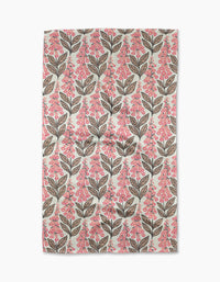 The Foxglove Finery tea towel by Sarah Daugherty features a symmetrical, evenly spaced pattern of brown leaves and pink berry clusters on light beige, crafted from quick-drying recycled materials.