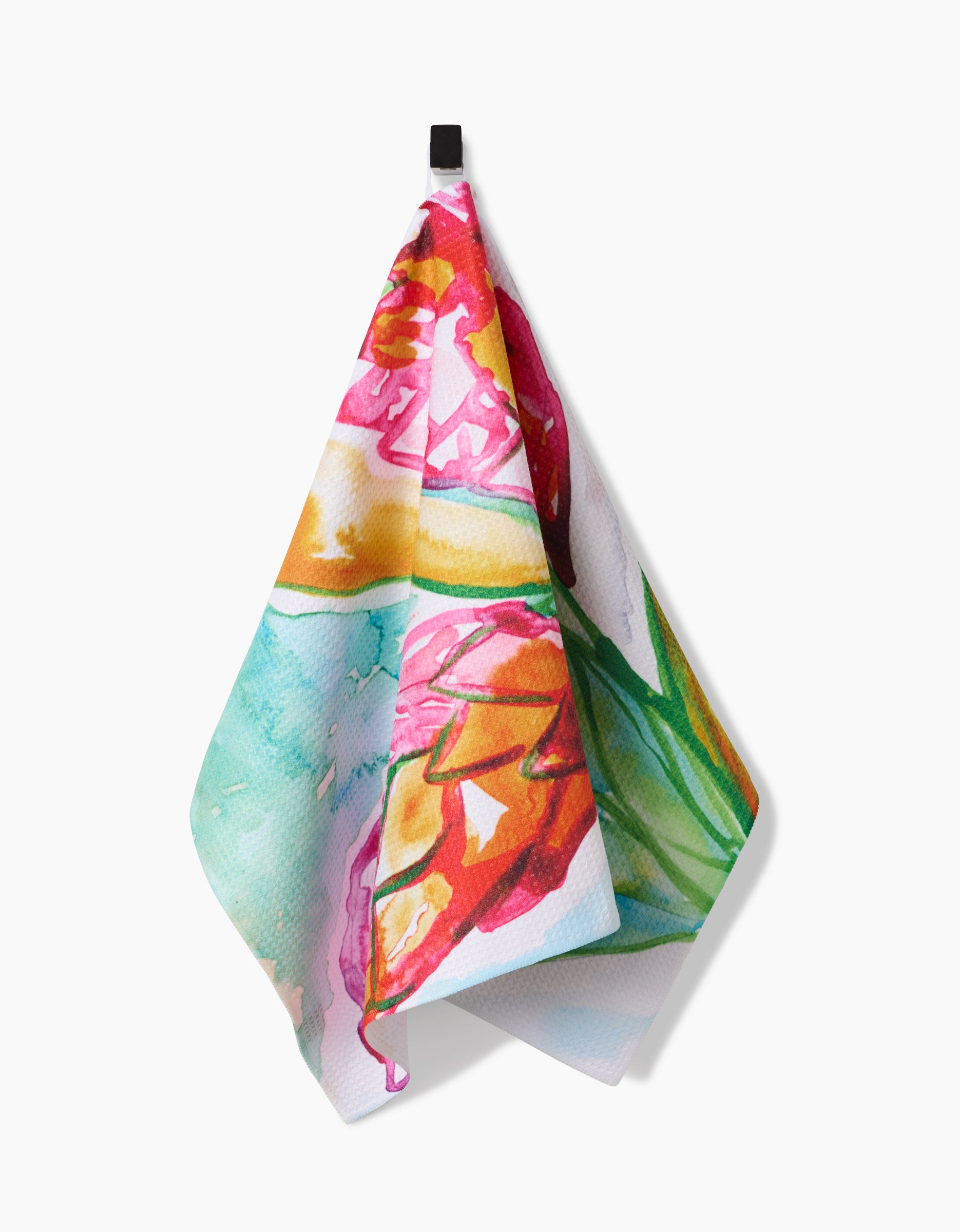 The Skye Walker Ginger tea towel, crafted from ultra-absorbent Geoweave fabric, showcases a vibrant abstract floral design in red, green, yellow, and blue as it hangs from a black hook on a white background.