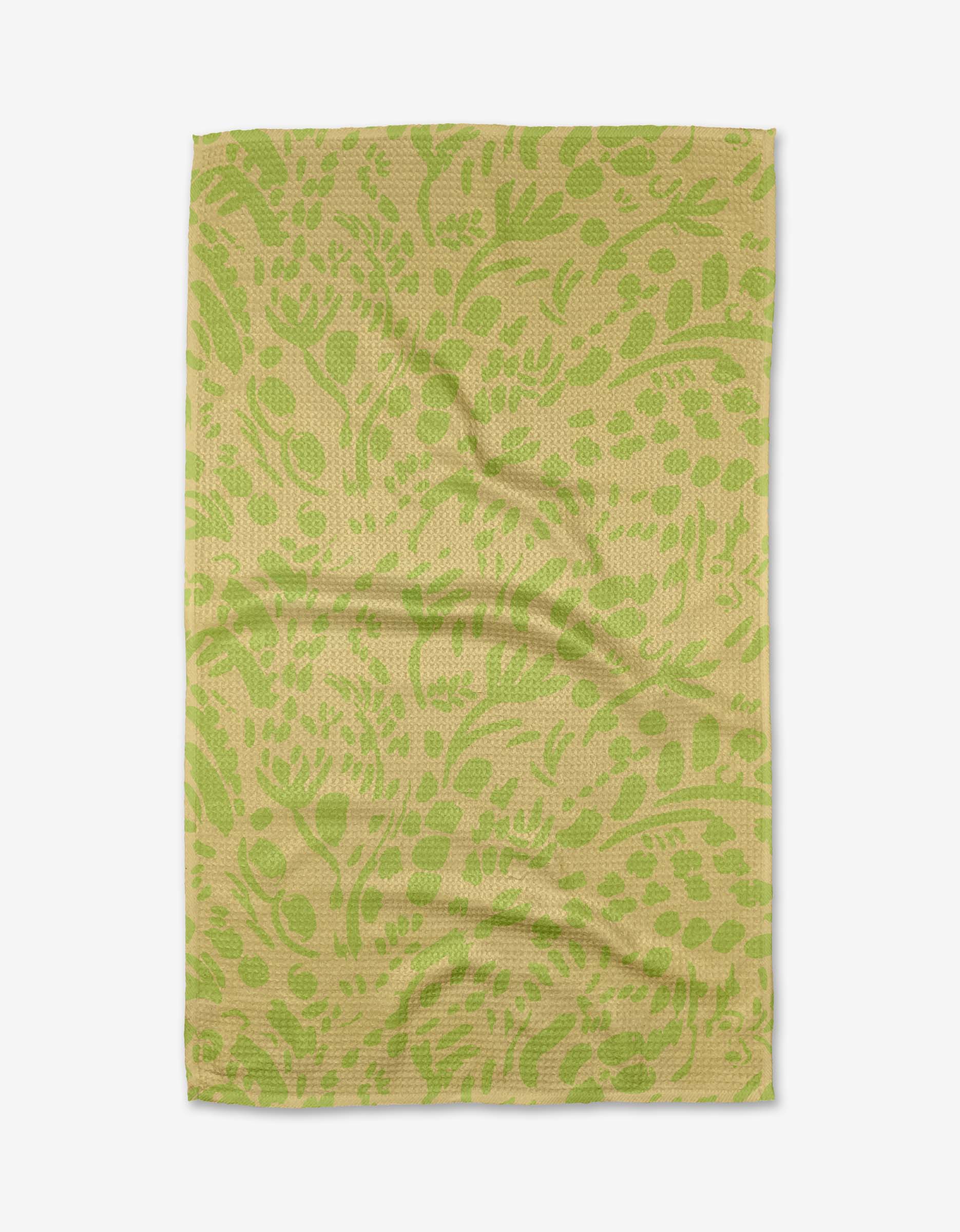 The Green Spring tea towel by Sareka Unique is rectangular, olive green and beige with a botanical leaf and flower pattern, made from recycled materials, and shown flat on a white background.