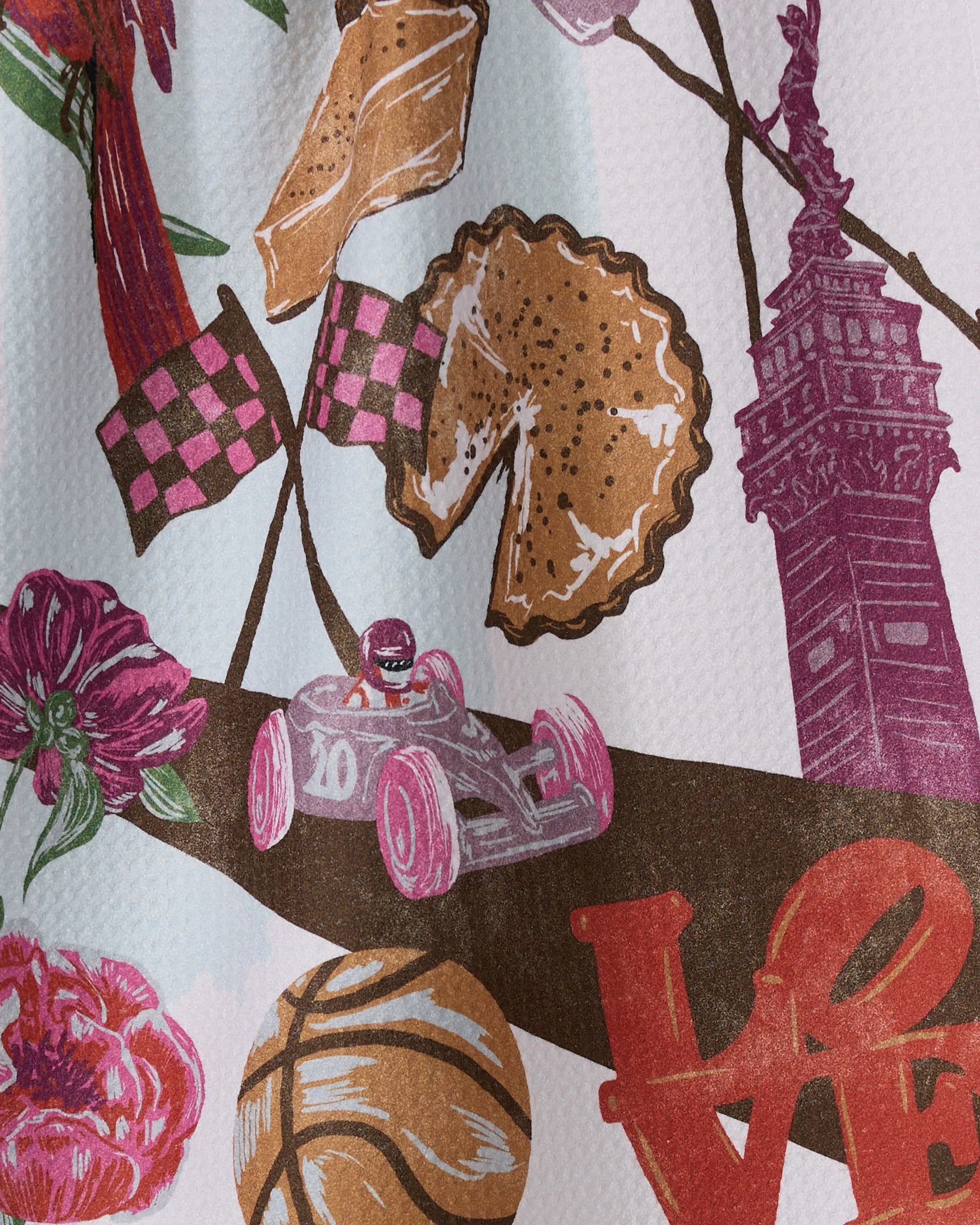 A vibrant illustration on Geometry’s ultra-absorbent tea towel, "Greetings From Indiana," featuring flowers, a race car with the number 10, a basketball, pie, checkered flags, and iconic Indiana landmarks.