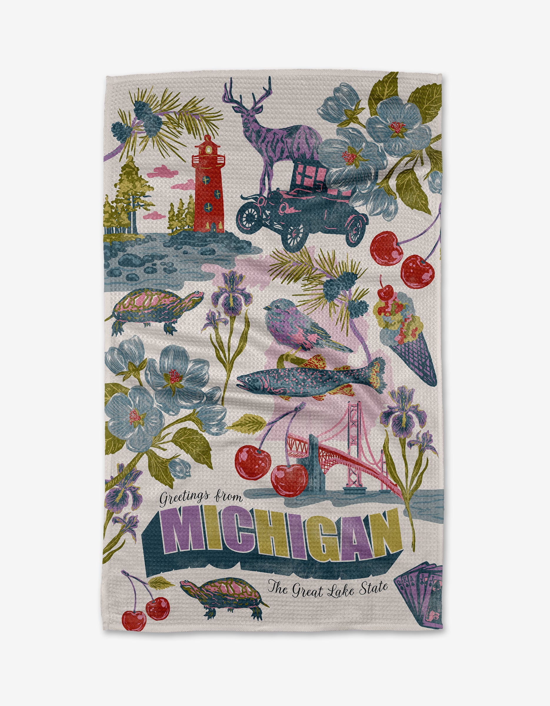 The Geometry “Greetings From Michigan” kitchen towel showcases vibrant illustrations of Michigan icons—deer, lighthouse, cherries, Mackinac Bridge—and reads “Greetings from Michigan, The Great Lake State.” Perfect as a lively tea towel for your home.