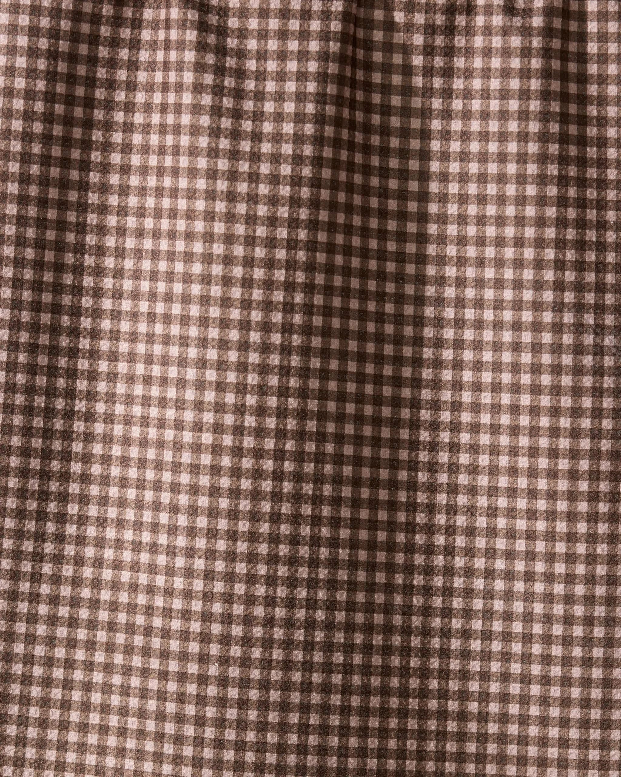 Close-up of Hearth by Geometry, a recycled kitchen towel featuring a brown and cream gingham check with small squares in a repeating grid. The fabric is softly gathered at the top, highlighting its eco-friendly design.