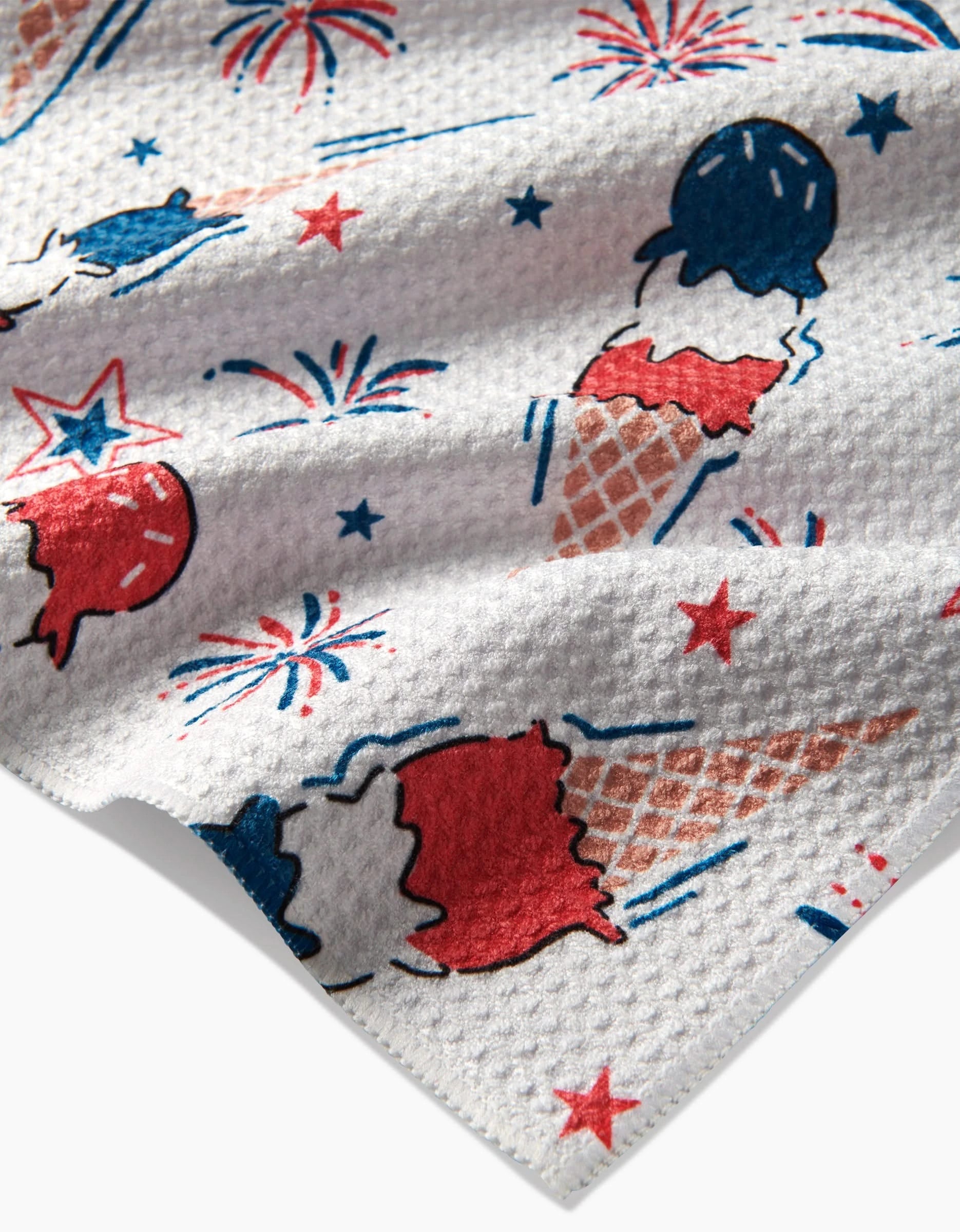 Add cheer to your kitchen with Hufton Studios Ice Cream Celebration Tea Towel—a textured white, recycled piece featuring red, white, and blue ice cream cones, popsicles, fireworks, and stars in a festive patriotic pattern.