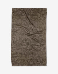 Imprint by Studio Jeannot is a rectangular brown tea towel featuring an abstract, swirling pattern like fingerprints or topographic lines. Made from recycled materials, it’s stylish, eco-friendly, and shown flat on a white background.