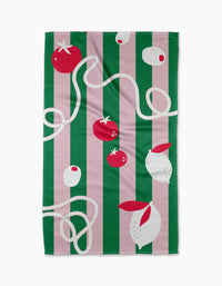 The Italian Mood dish towel by Marina Solodka features vertical green and pink stripes, plus illustrations of tomatoes, garlic, olives, and pasta in red, white, and cream for a vibrant kitchen accent.