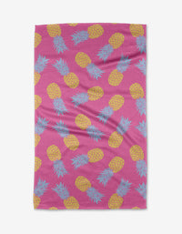 The Juicy Pineapples towel by Ashley Celena features a pink backdrop with yellow pineapples and blue-green leaves, made from ultra-absorbent Geoweave fabric for superior drying.